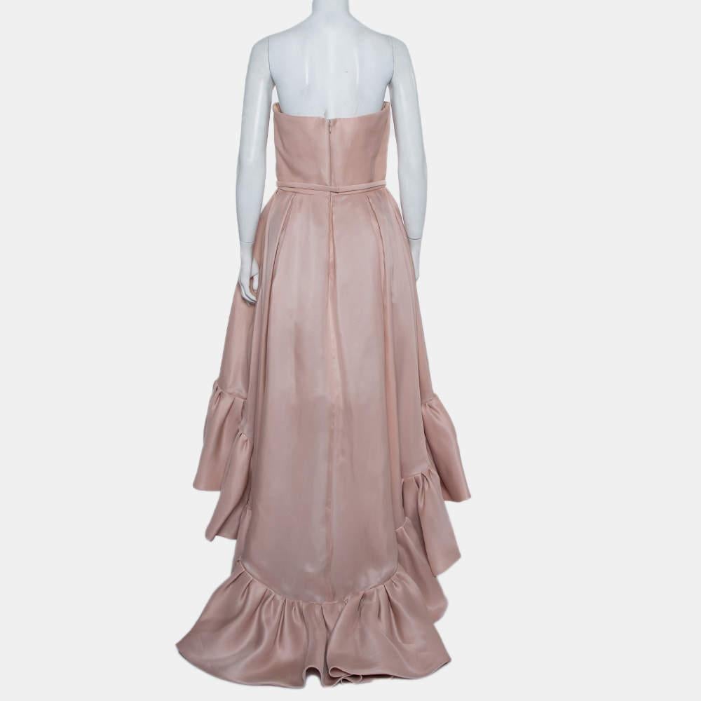 Effortless and exuding grace, this Reem Acra creation will make sure your special evening is spent well. Crafted from luxurious silk, it carries a beautiful shade of pink that adds to the soft silhouette of the strapless gown. The straight bodice