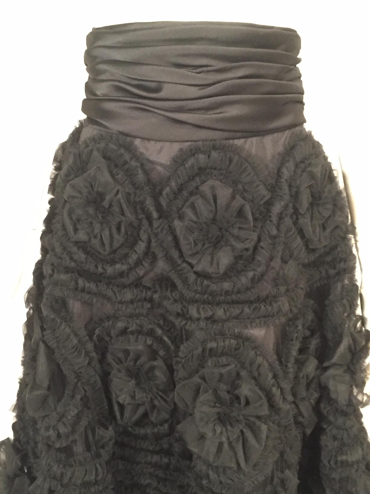 This is a delightful evening skirt made from a layer of black net. The net is completely covered with rows of gathered tulle which encircles the three dimensional tulle flowers. The flowers are graduated in size, starting at 3 1/2