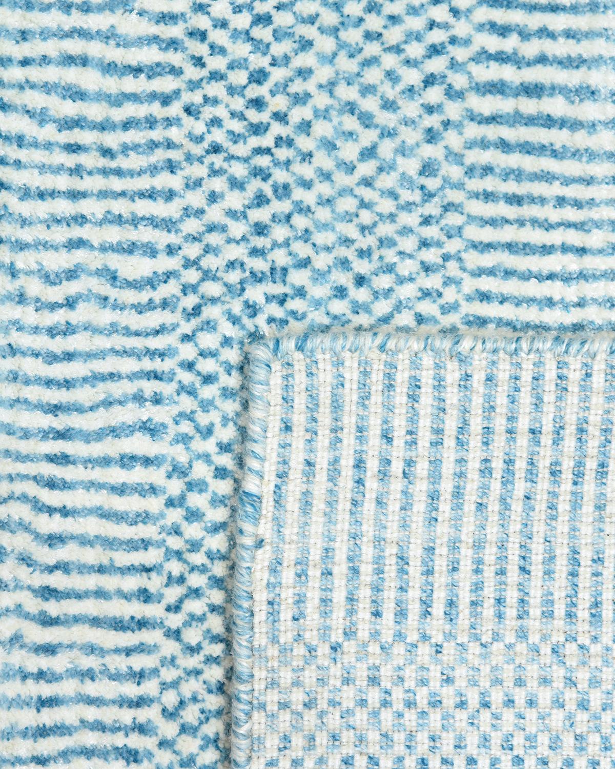 Color: Aqua, made in India. 60% wool, 30% viscose, 10% cotton. Subtle tone-on-tone stripes give the solid collection a depth and sophistication all its own. These rugs can pull the disparate elements of a room into a beautifully cohesive whole; they