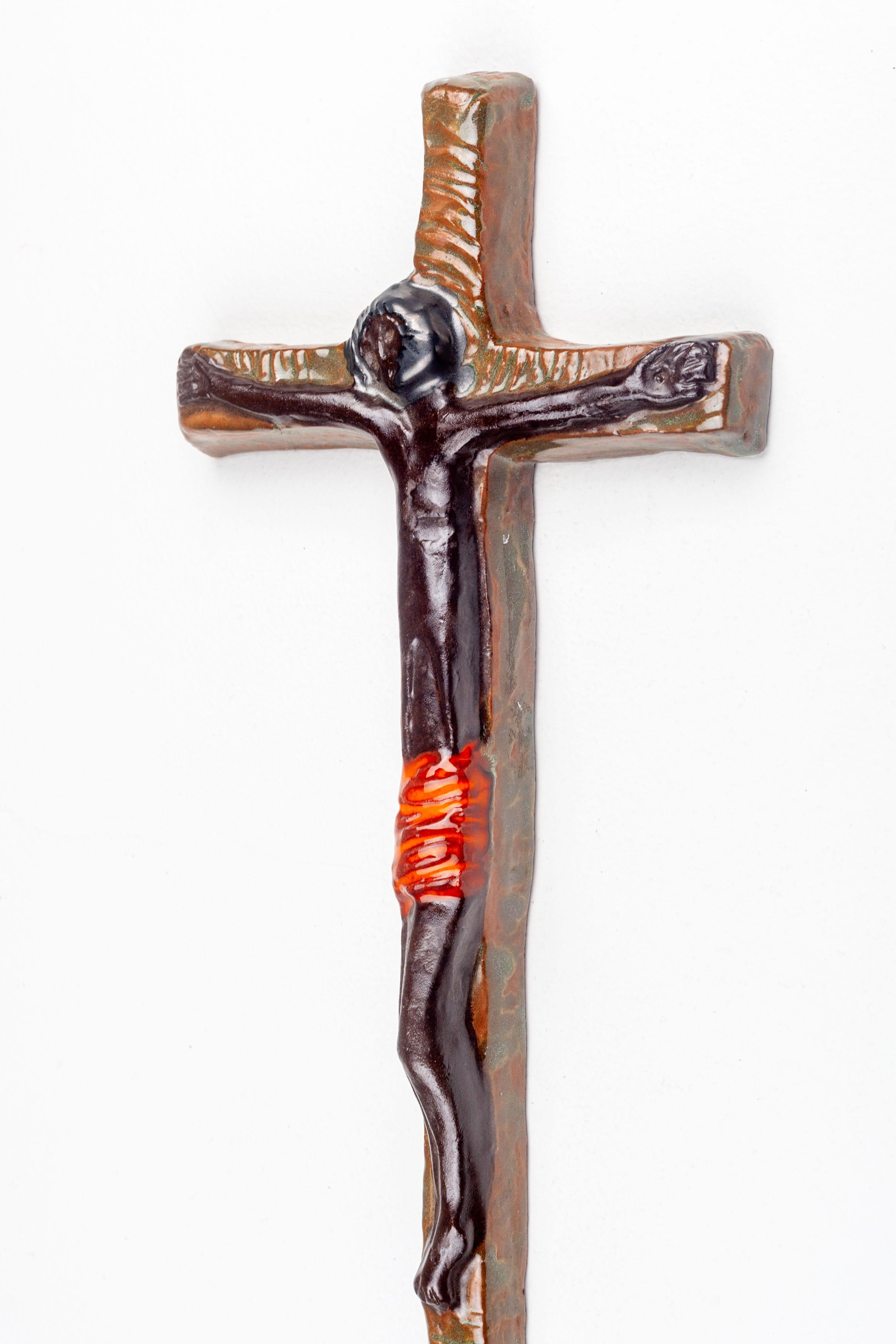 This evocative piece of mid-century modern religious art represents a fusion of traditional iconography with the abstract, minimalist sensibilities of the period. Handcrafted by a European studio artist, the ceramic cross showcases a distinctive