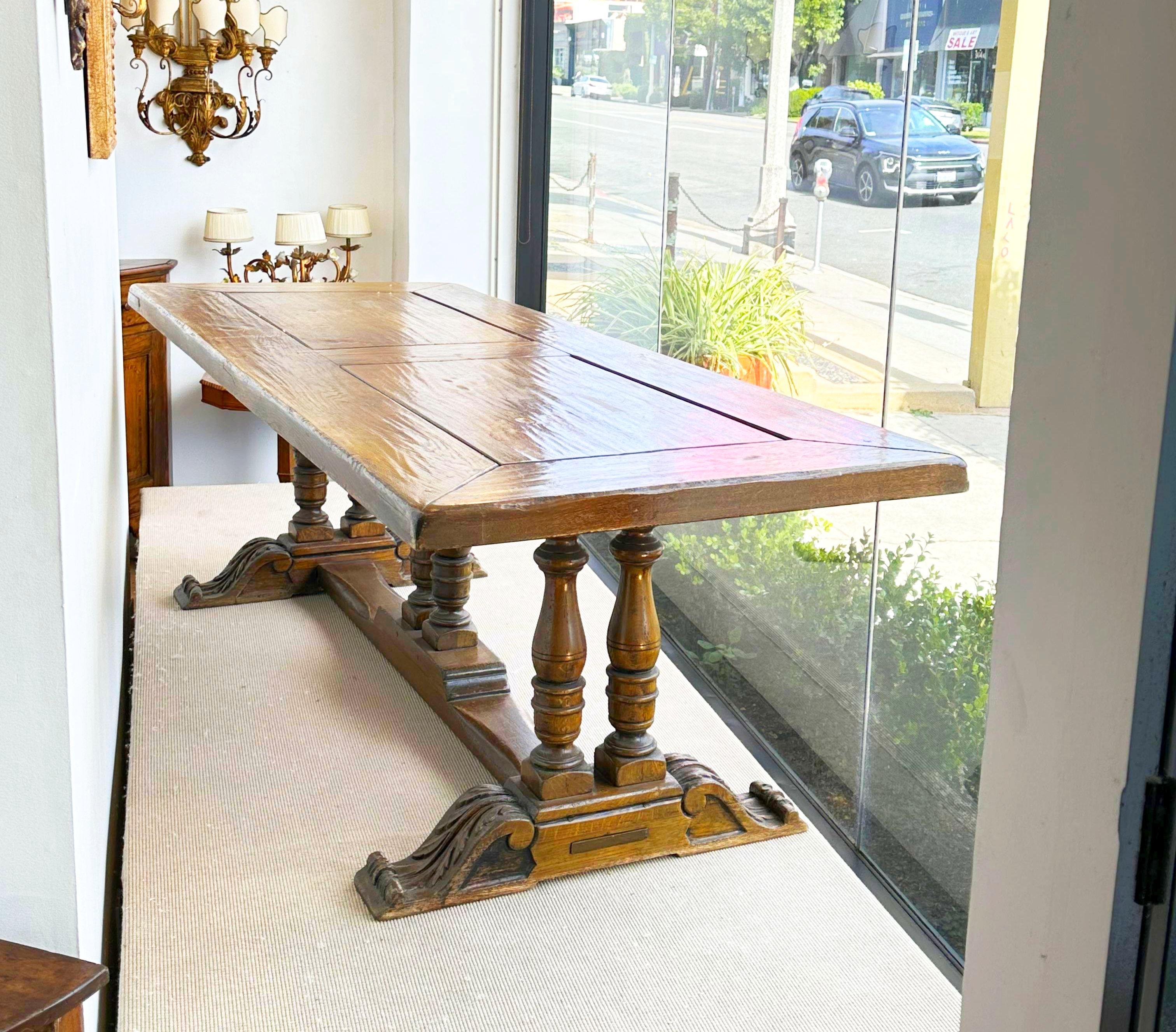 French walnut farm table, the rectangular top raised on columnar legs ending on trestle base joined by stretchers.