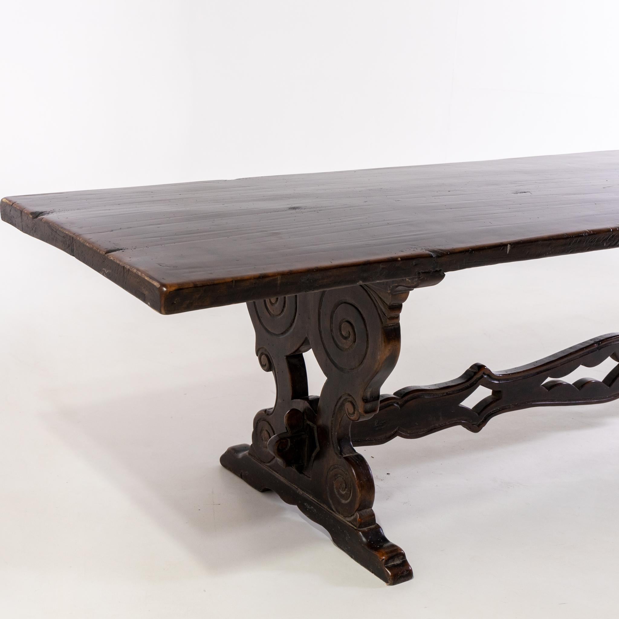 Large refectory table in walnut with beautiful patina and carved intermediate bracing.