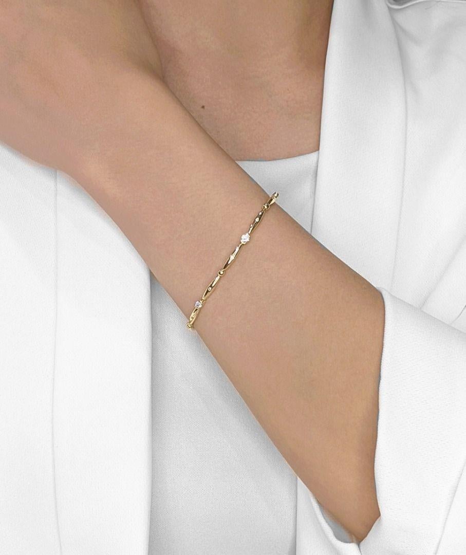A seamless blend of sophistication and understated luxury, this 18K yellow gold bracelet is adorned with nine round brilliant-cut natural diamonds, totaling 0.037 carats. Each diamond, graded G-H color and VS-SI clarity, adds a subtle yet radiant