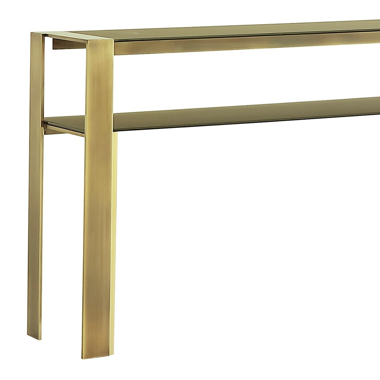 Console table refined bronze with bronze frame
structure in glossy brass patinated finish and with
up and down tops in tempered glass in bronze finish.