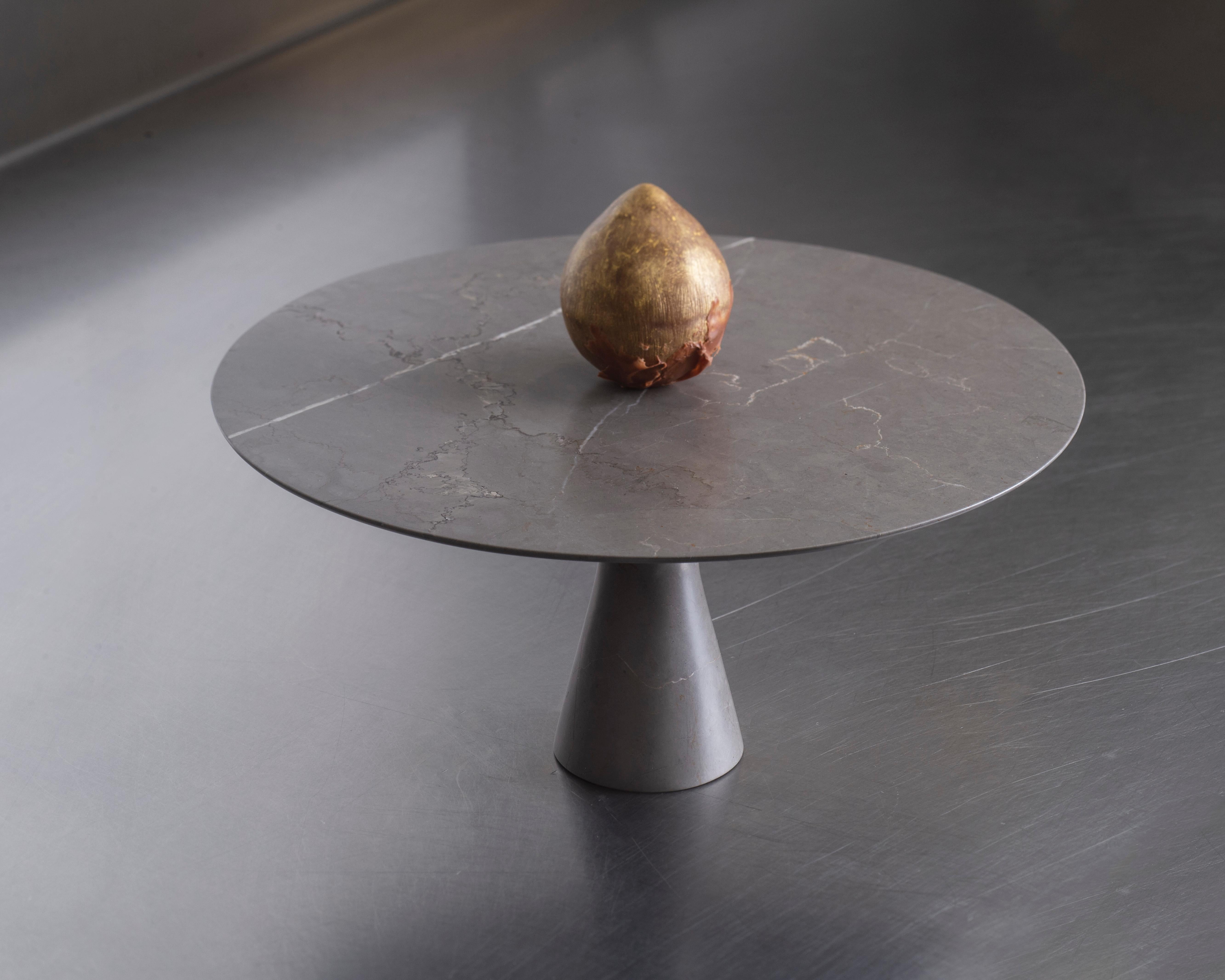 Refined Contemporary marble serving plate.
Dimensions: ø 32 x 15 cm H

Angelo O is the little brother and scale model of the natural stone table Angelo M. Angelo O can ideally be used as a cake plate, cheese platter or to serve other
