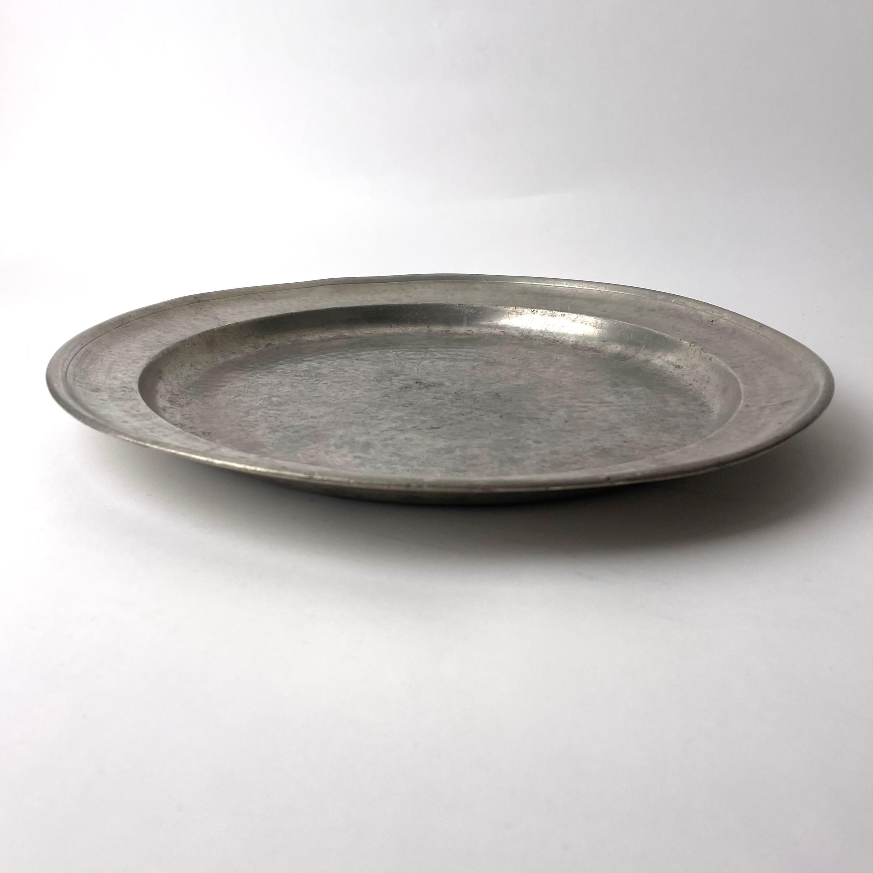 Refined Swedish Gustavian Pewter Platter, Late 18th Century Sweden

A beautiful pewter platter from the Swedish Gustavian period of the late 18th century. Wonderfully worked metal, with a small stamp-like decorative elements that add an element of