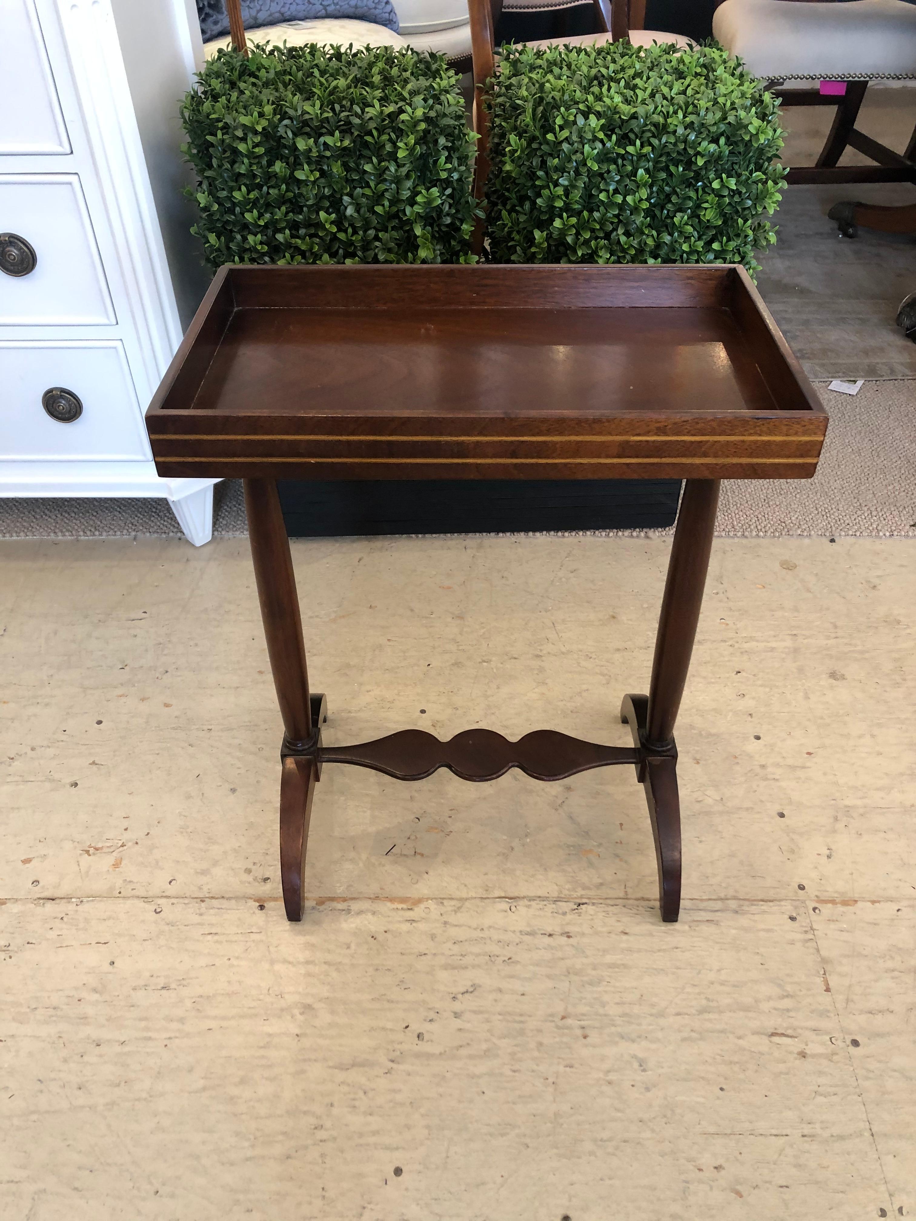 Great looking mahogany tray style drinks table having rectangular top with handsome satinwood inlay around the exterior gallery and lovely scalloped stretcher between two legs with crescent shaped feet.