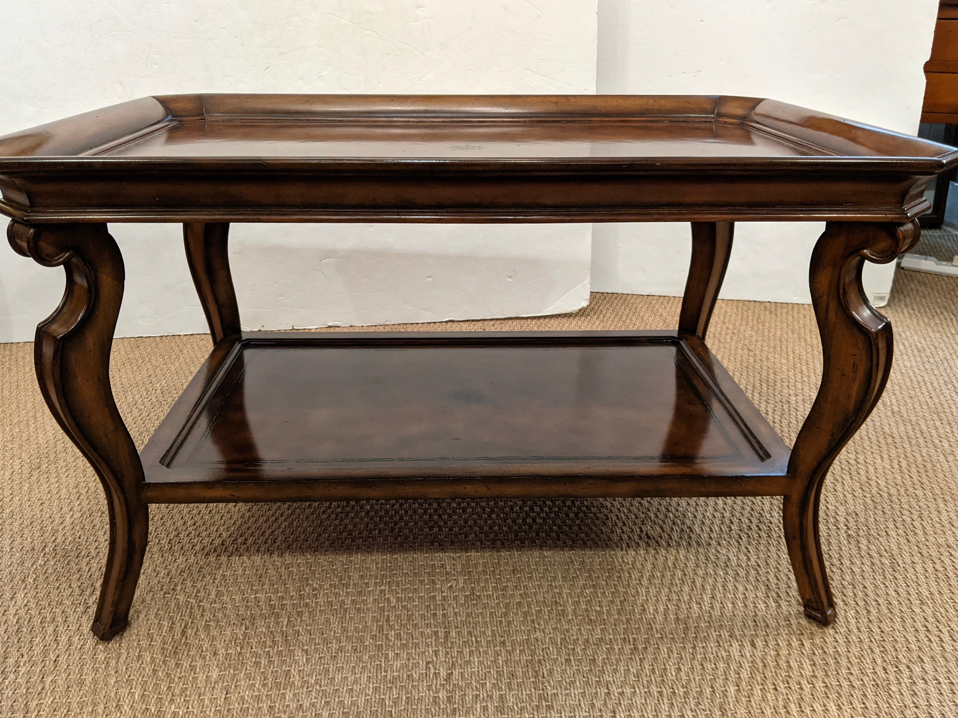 Very elegant two tier burled walnut coffee table having gallery around the top and cabriole shaped legs.