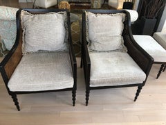 Refined Pair of Ebonized Double Caned Upholstered Club Chairs and Ottomans