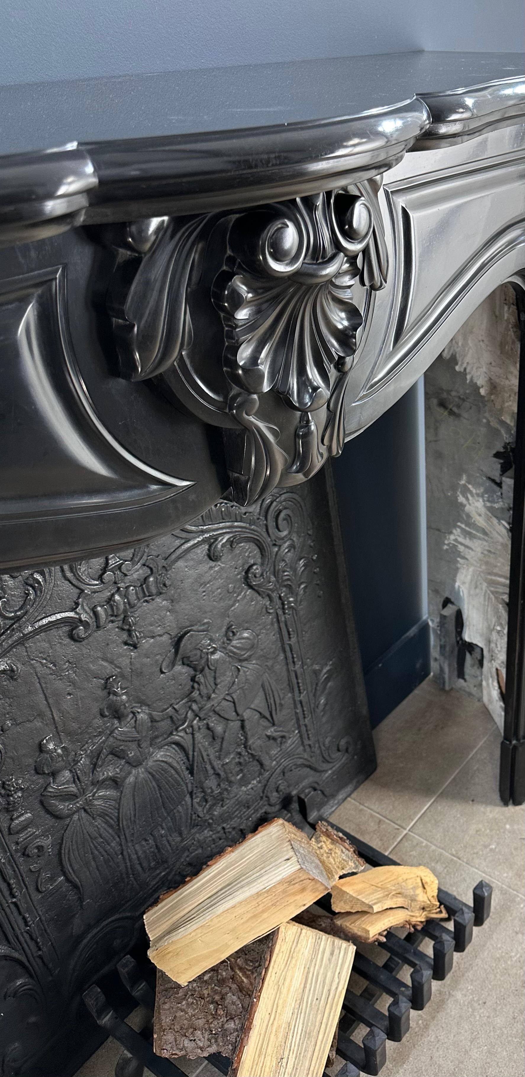 Hand-Carved Refined Splendor: Louis XV Style Noir de Mazy Antique Marble Front Fireplace For Sale