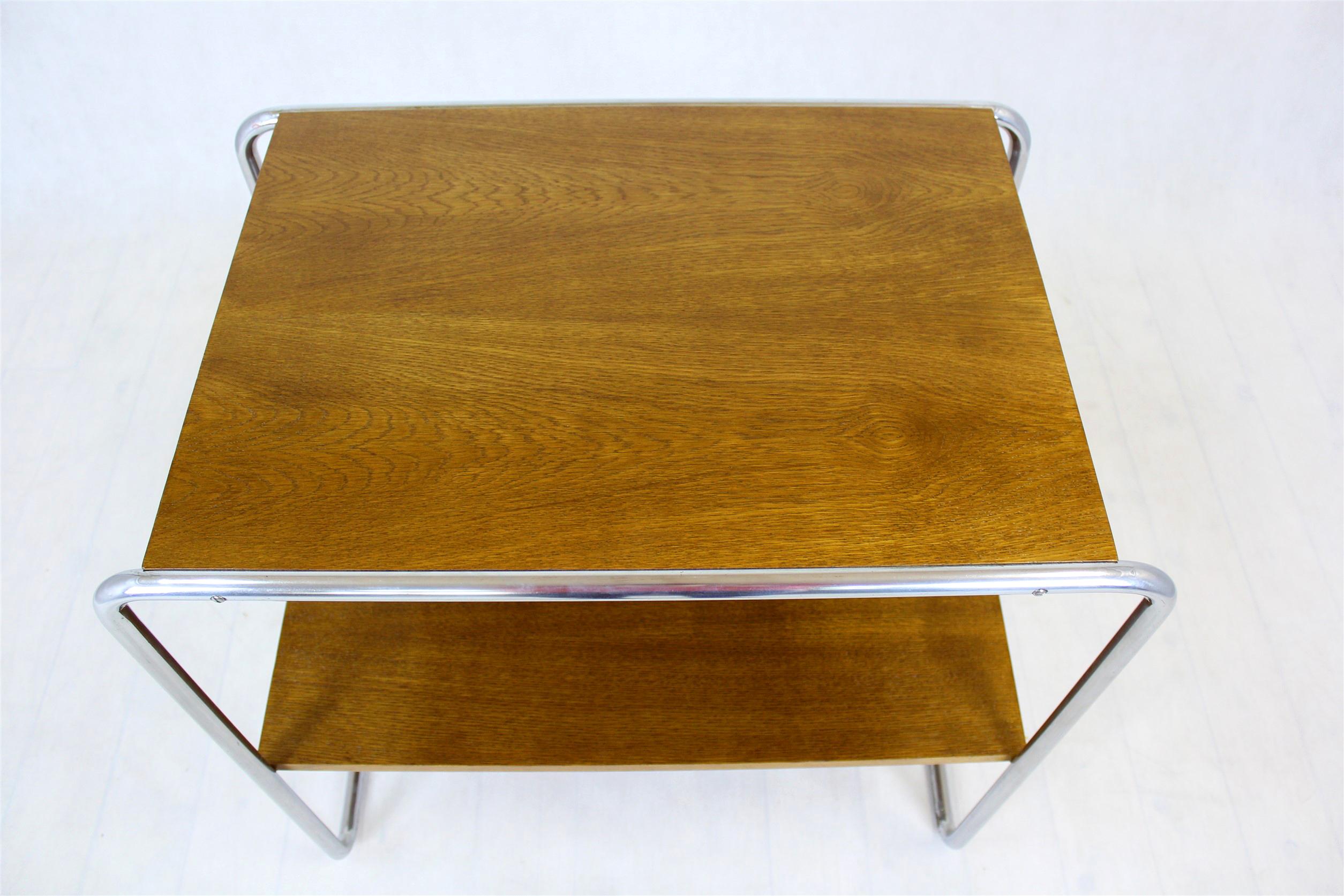 
Cette table console (mod. B12) a été conçue par Marcel Breuer dans les années 1930. Il comporte deux étagères soutenues par un cadre en tube d'acier chromé. Les éléments en bois ont été restaurés, vernis, les chromes sont conservés dans leur bon