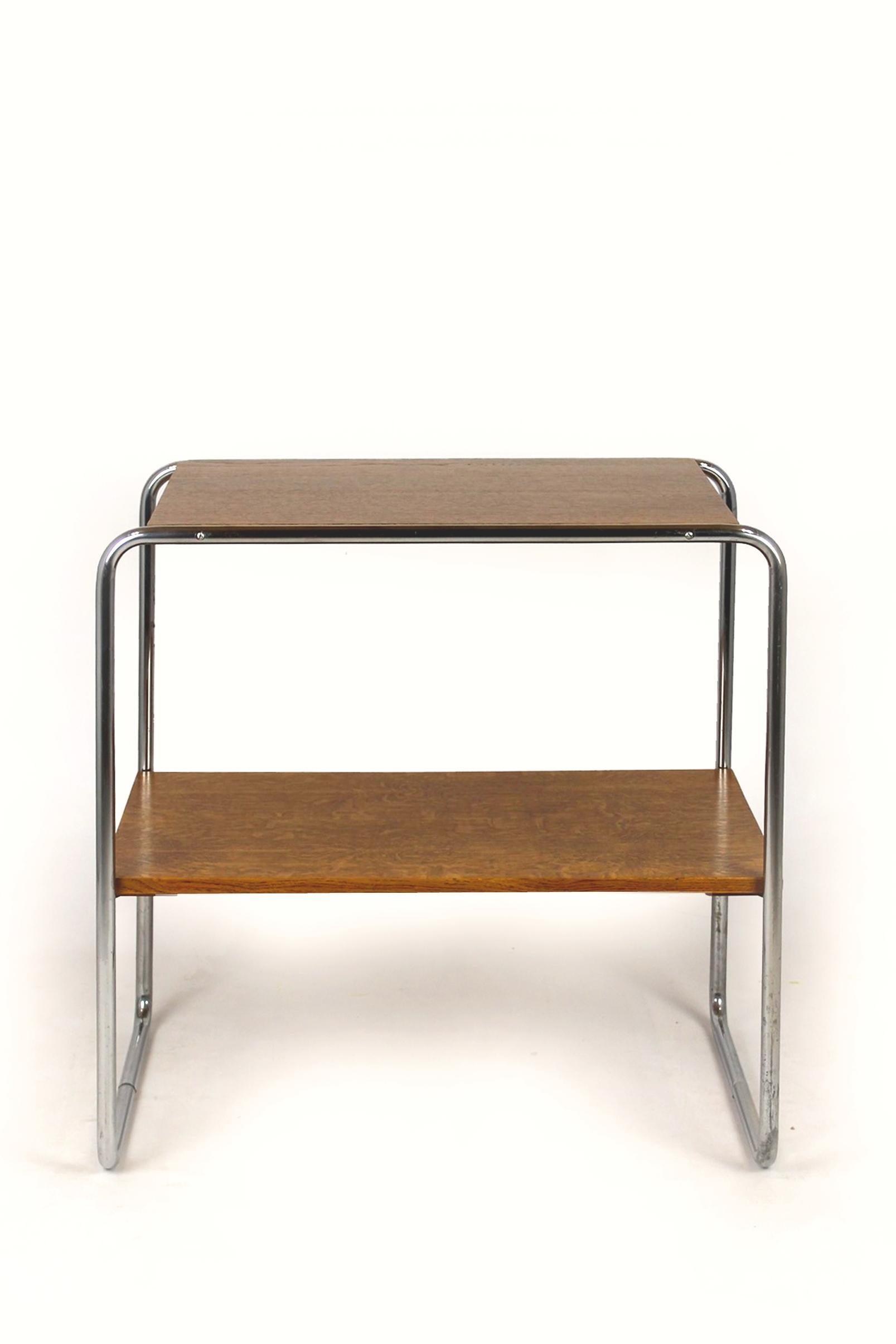 
This console table (mod. B12), was designed by Marcel Breuer in the 1930s. It features two shelfs supported by a chrome tubular steel frame. The wooden elements have been restored, varnished, the chrome is preserved in its original good condition