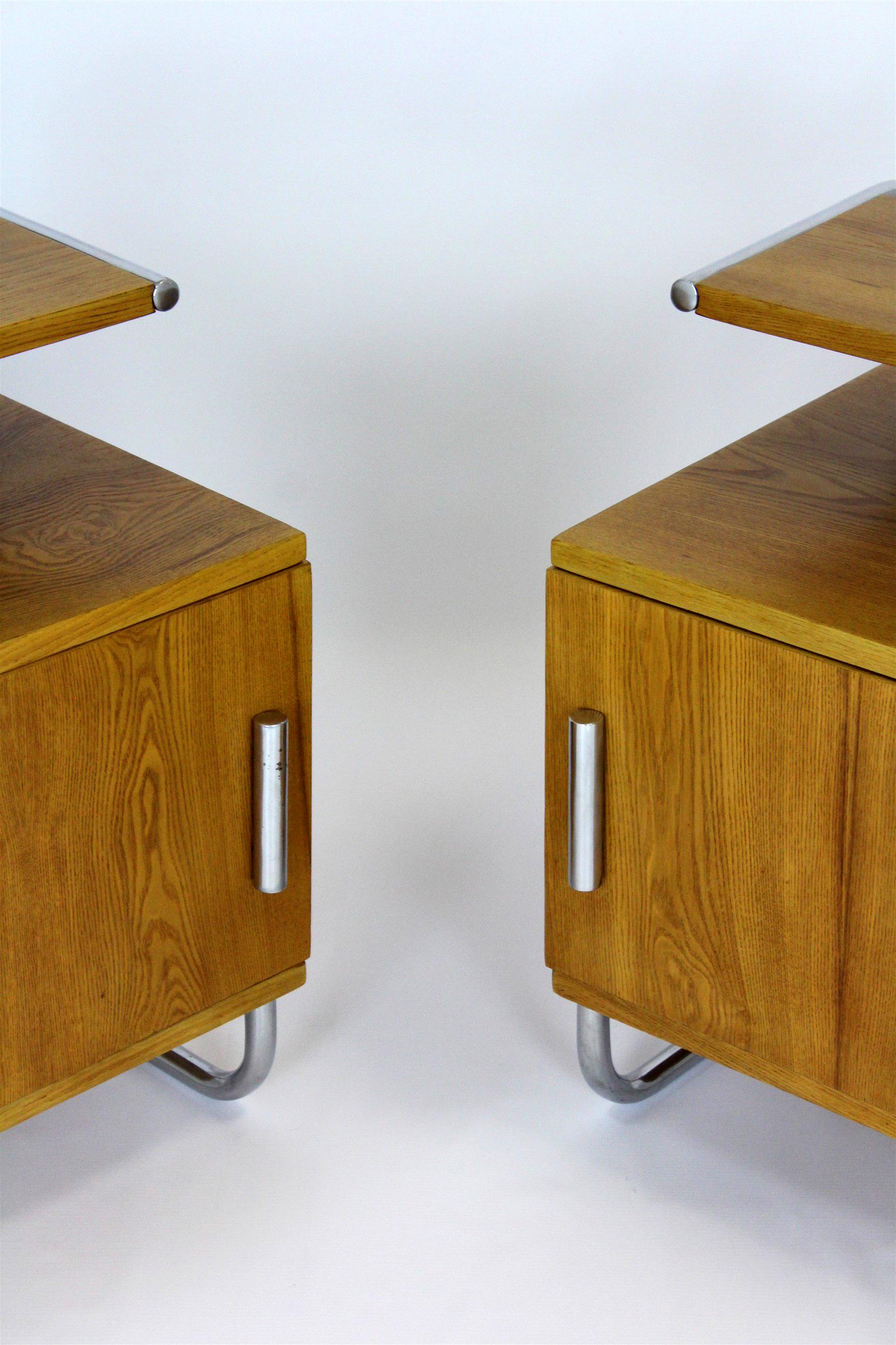 This set of two Bauhaus style bedside tables was produced in the 1940's by Famed Zadziele. They are made of oak and a chrome tubular steel frame. The Famed company was founded in 1921 and produced tubular furniture, also under license from Thonet