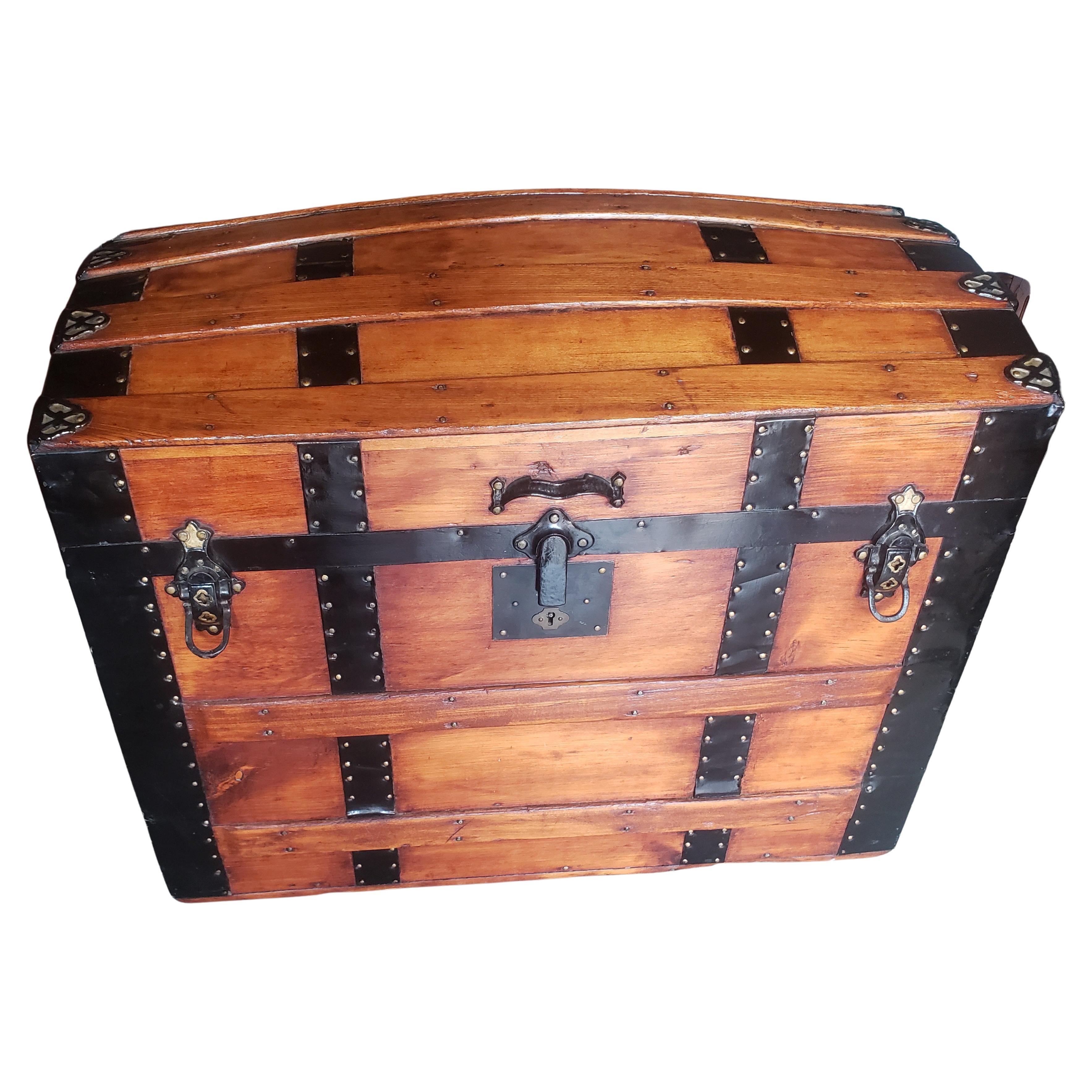 A gorgeous, completely Refinished Early American Steamers Dome Top Pine and iron Trunk / Blanket Chest Trunk on wheels and lined with American Colonial scenes textile. Great for Blanket andnother belongings storage.
