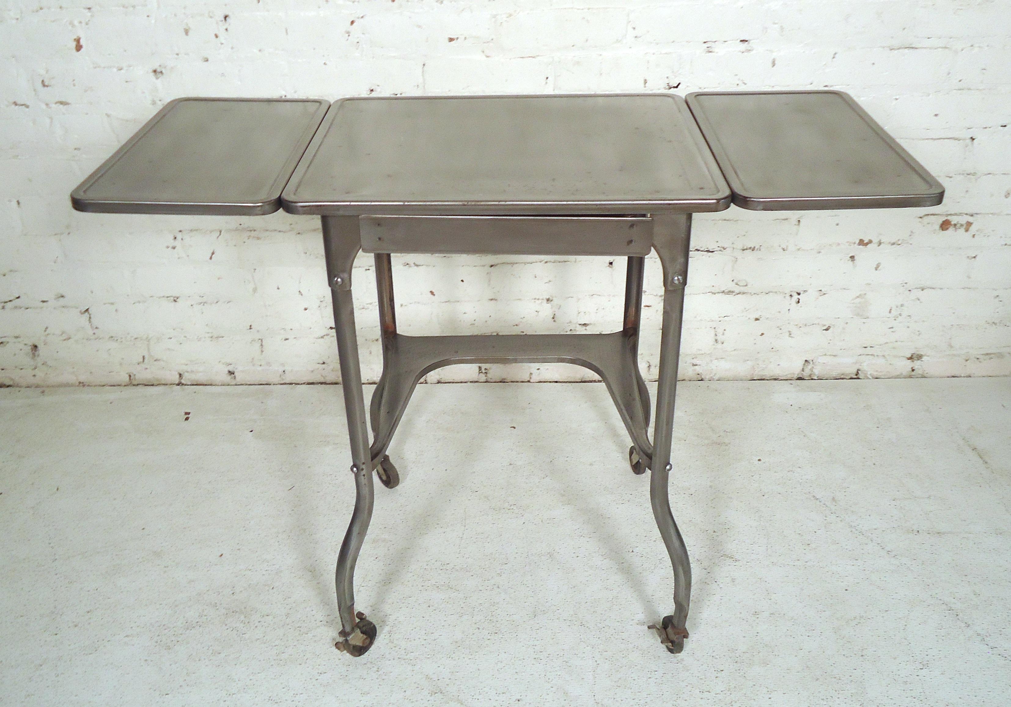 Small side table restored in a bare metal style finish. Features a pair of drop leaf extensions.
(Please confirm item location NY or NJ with dealer).