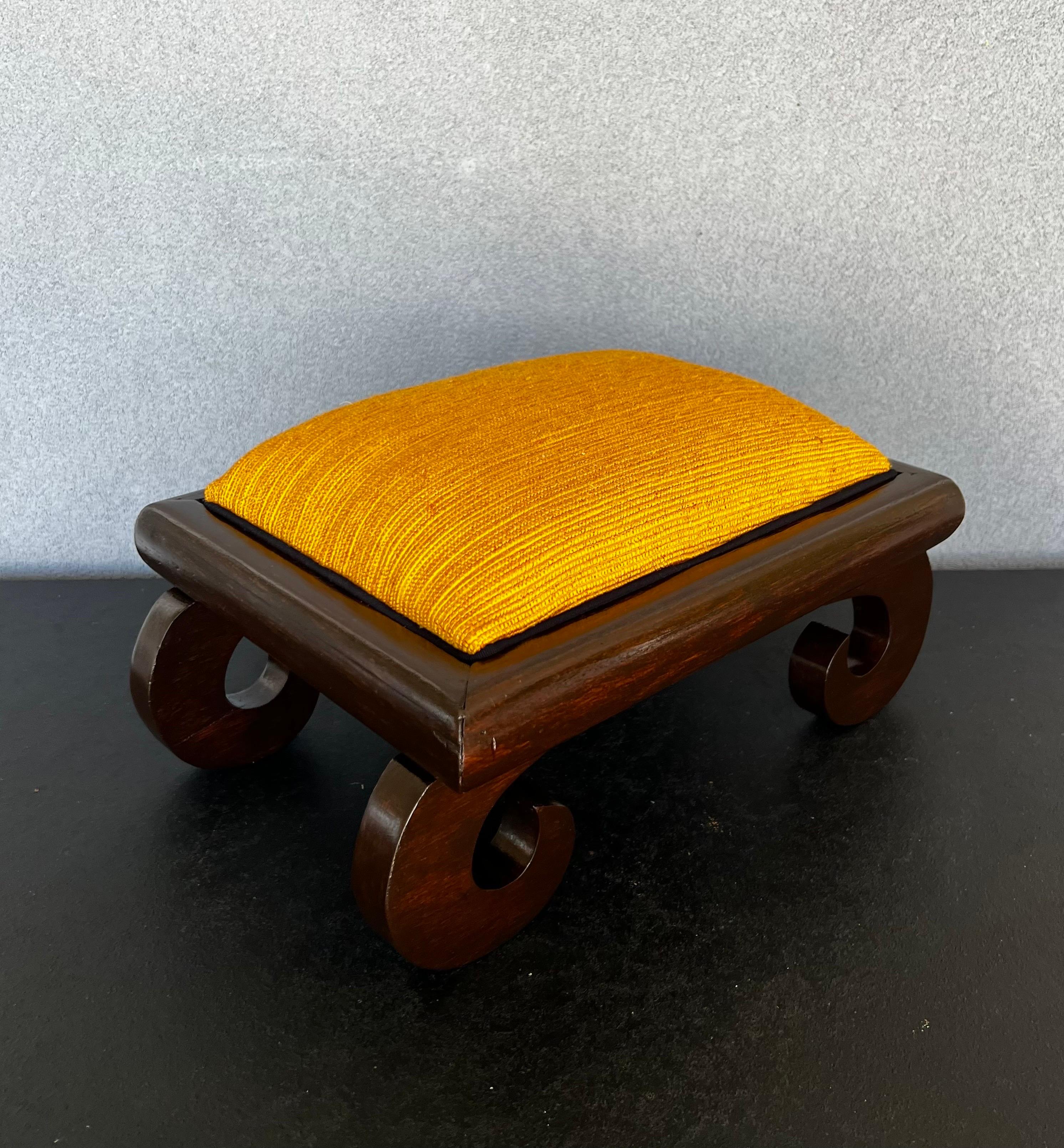Gorgeous small refinished vintage Asian footstool with scroll legs and gold/orange fabric with accent black velvet piping 
this stool is the perfect addition to any room or bedroom as a finishing touch, it would add a touch of color and would bring