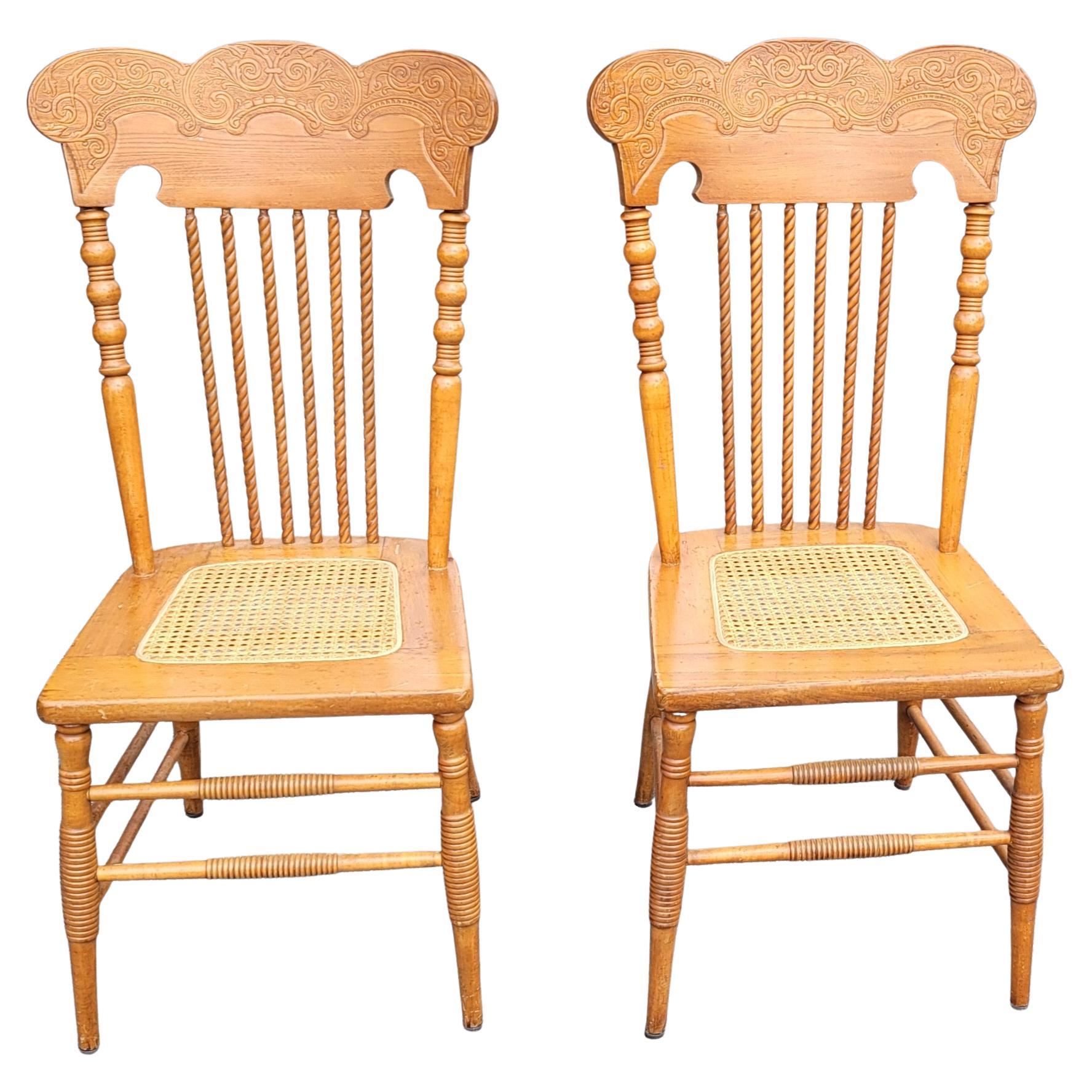 A recently refinished pair of Victorian style press back spiral maple chairs with cane seat. Cane has been redone. Feature a bobbing back supports with spiral spindles. Absolutely gorgeous pair that may may be used as needed in your dining room or