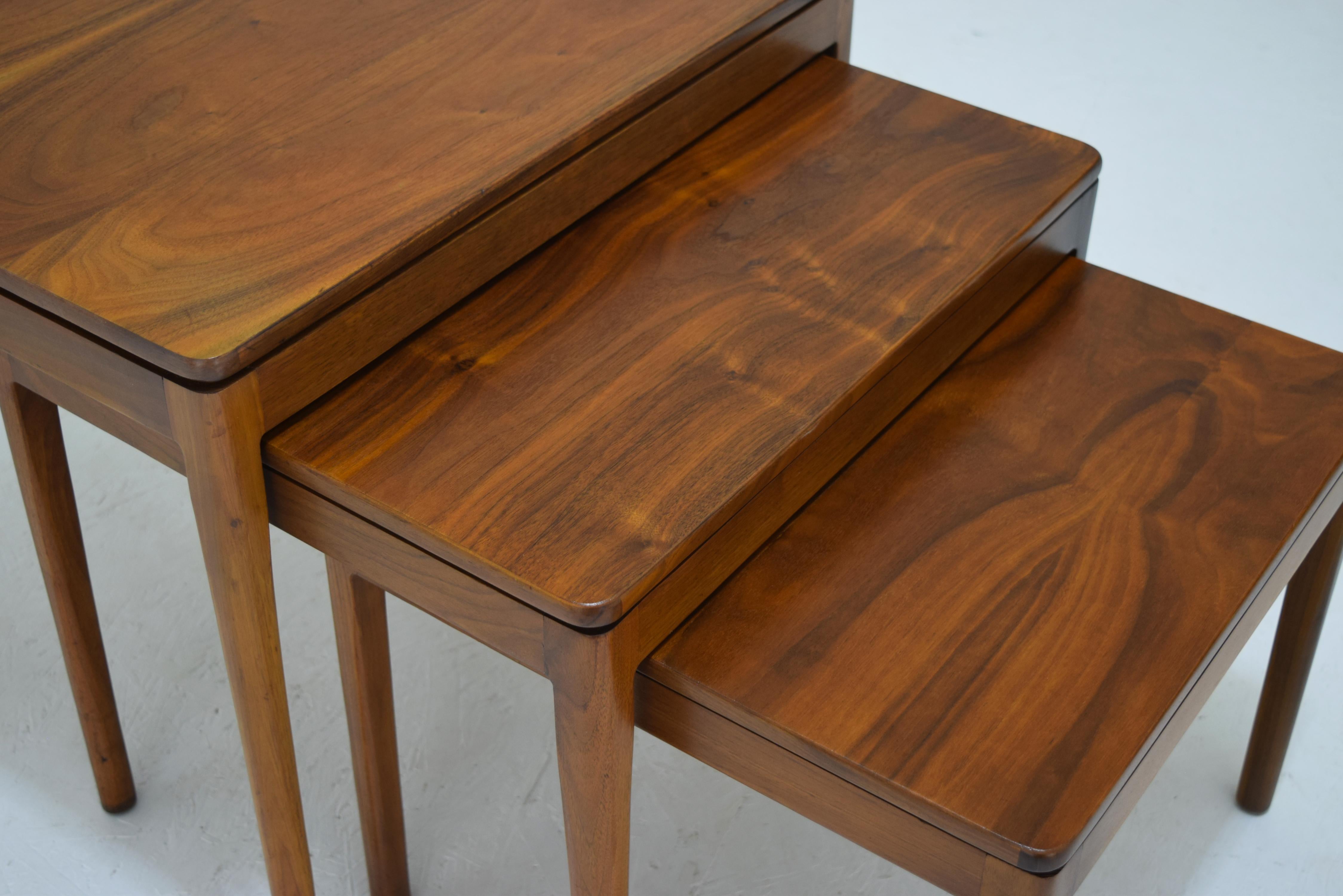 Like new.  In stunning condition with new lacquer surfaces and precisely color matched. All walnut construction. Nesting tables that stack for room saving modernism. Produced 1959. Marked to underside.
Sizes:
18 x 18 x 15.25