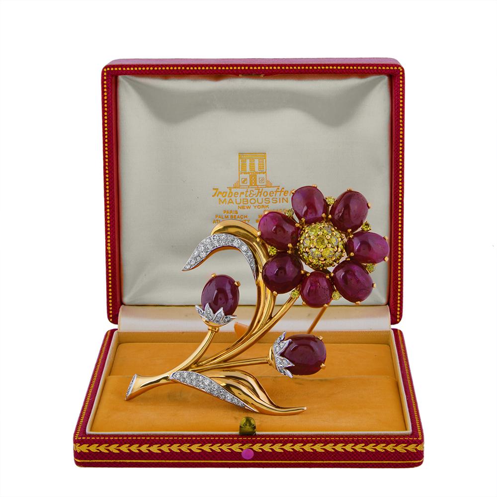 A ruby, diamond, gold and platinum brooch from the Reflection line by Trabert & Hoeffer Mauboussin, of floral design, set with cabochon rubies and yellow and near-colourless diamonds. Stamped with maker’s signature, numbered and signed ‘Reflection’.