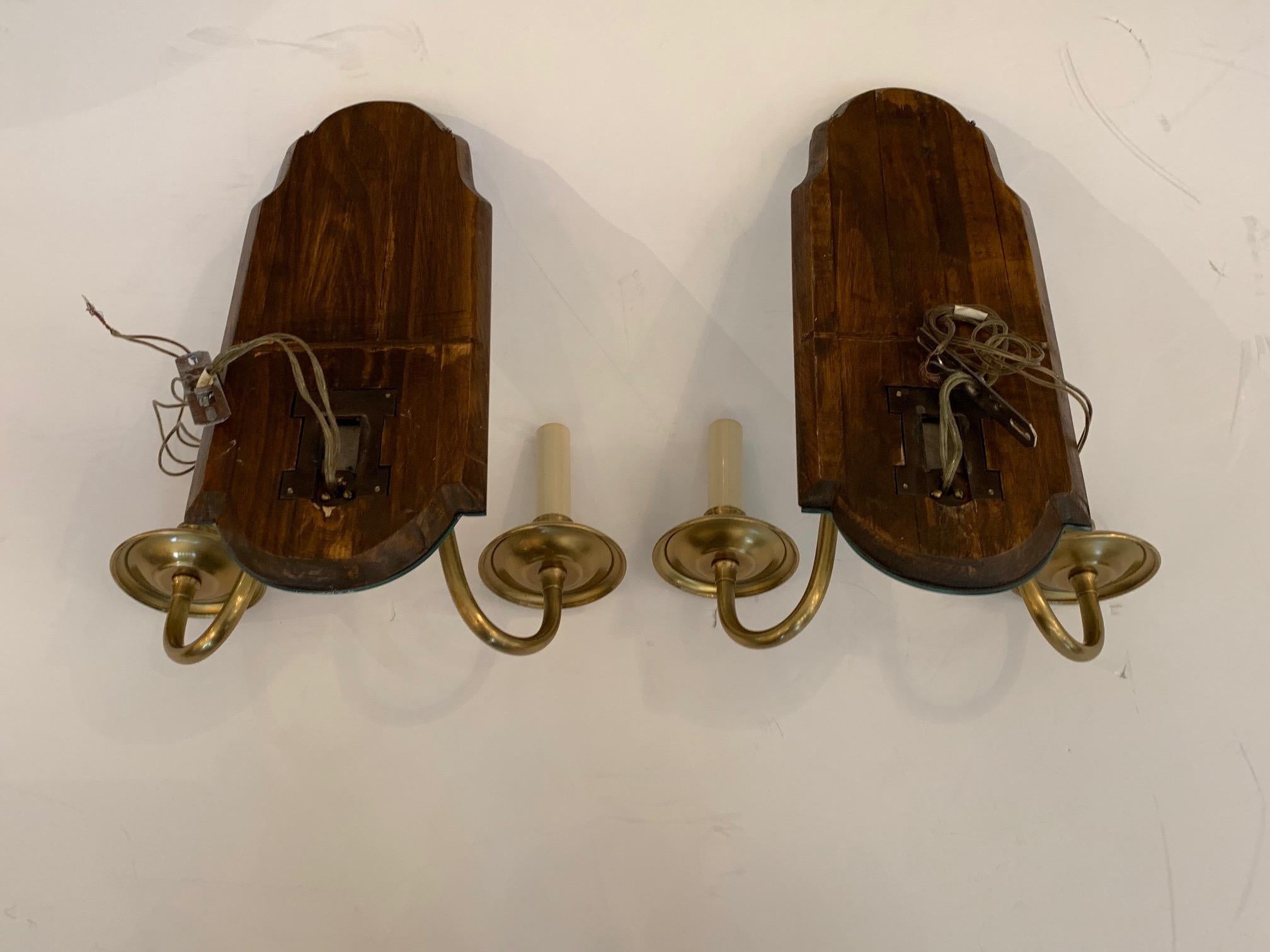 A pair of beautiful bevelled mirror key hole shaped wall sconces having two brass arms each and fully wired.
 