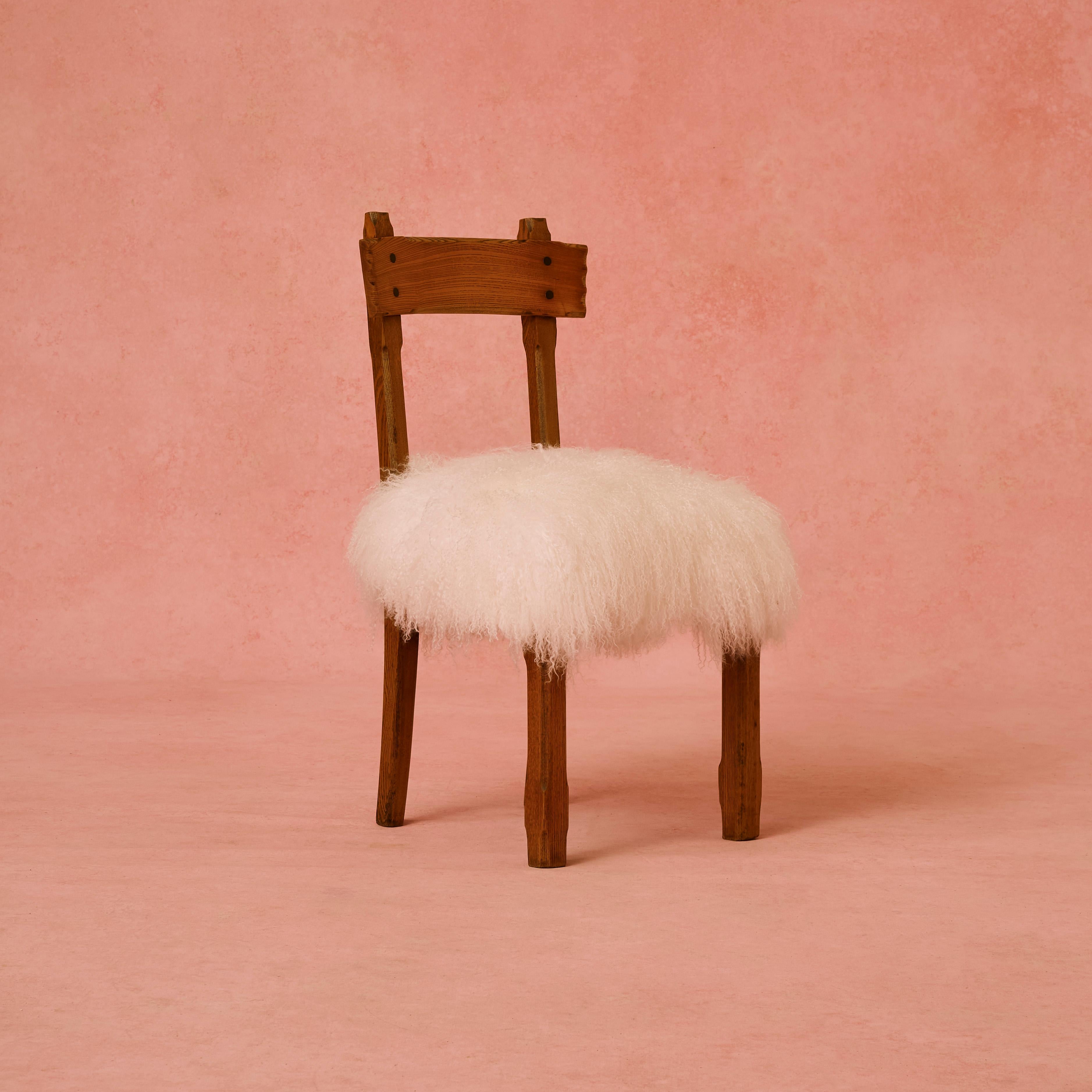 Reformed Gothic chair, attributed to Charles Bevan oak chair upholstered in White Mongolian sheepskin.