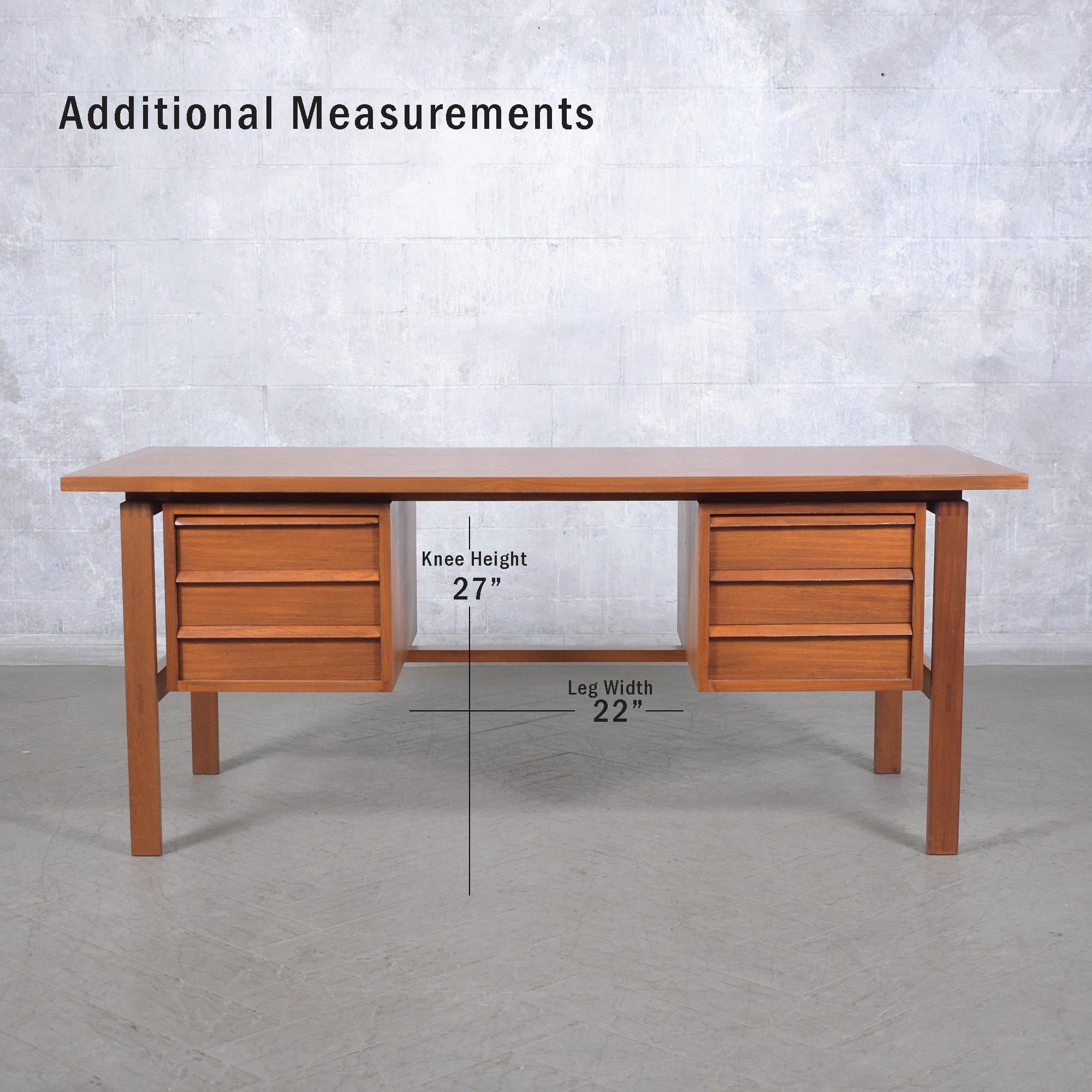 Explore the sophisticated craftsmanship of our Danish modern desk, meticulously restored by our in-house professionals. This vintage 1960s executive desk, crafted from teak wood and veneers, features a fresh stain in a light walnut color with a