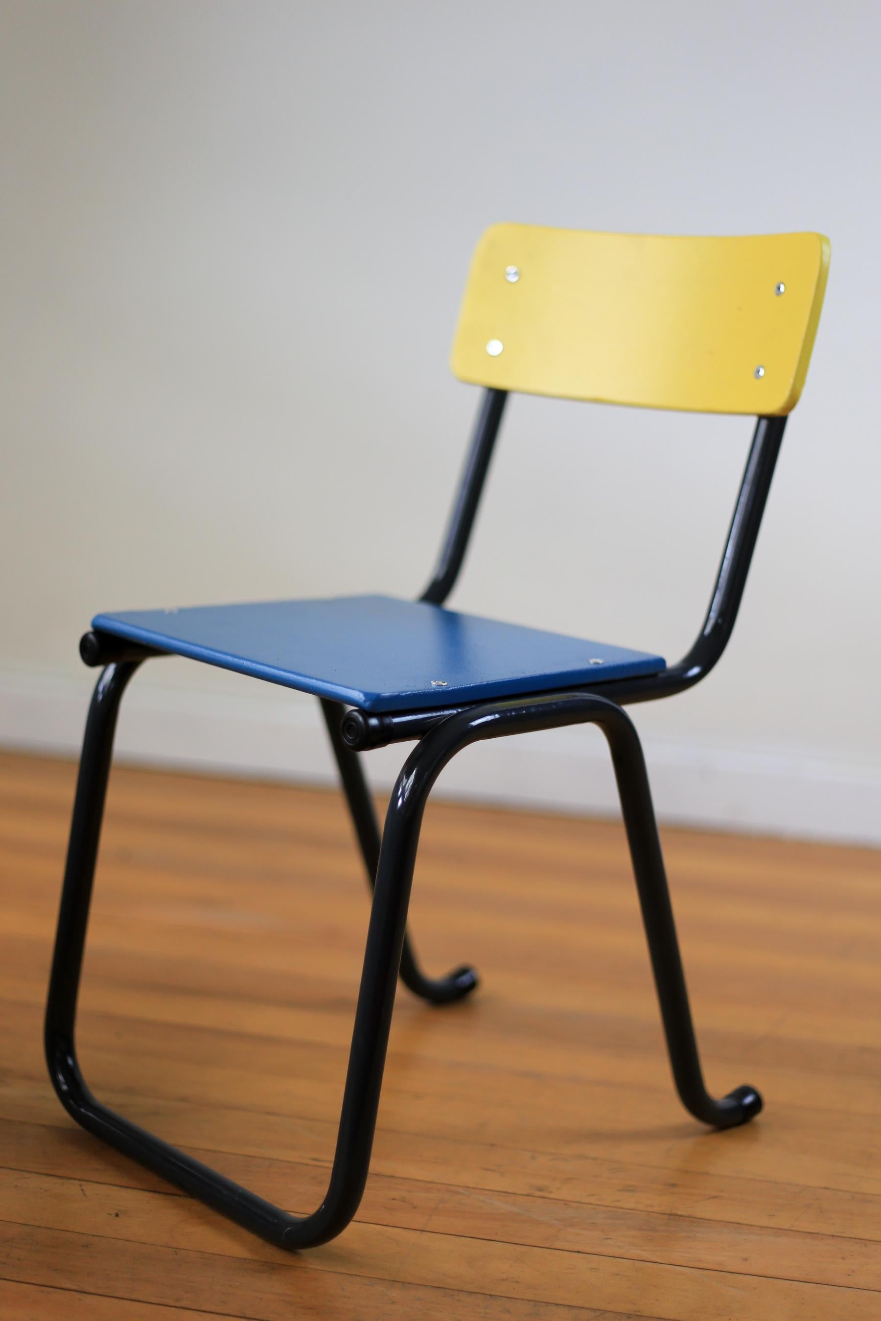 A set of four refurbished 1950s pre-school chairs. The original tubular steel frames are powder coated in a silk, dark grey finish and the compressed wood seats and backs - that miraculously stood the test of time - have been given another lease on