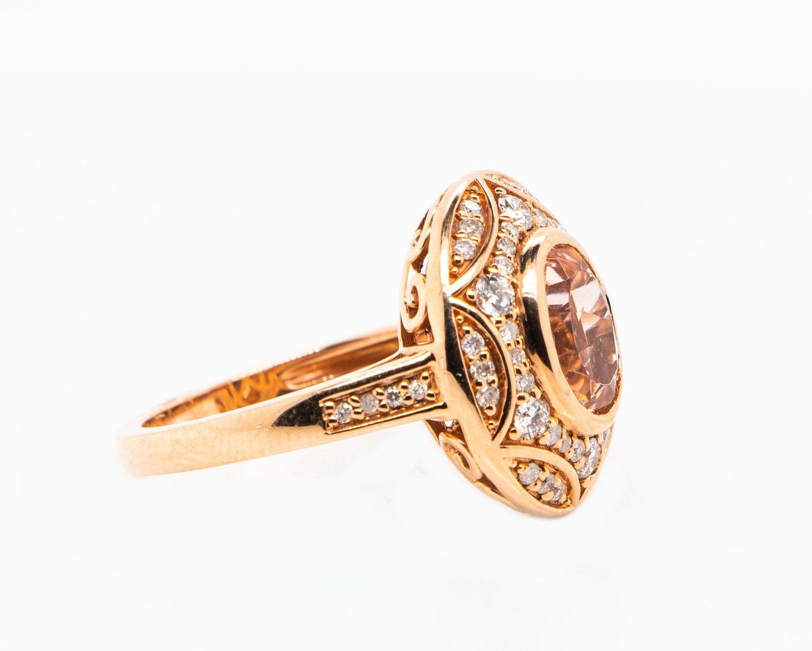 This is a magnificent natural 1.60carat morganite and diamond halo ring set in solid 14K rose gold. The natural and large 8X6MM Morganite oval has an excellent peachy pink color (AAA quality gem) and is set on top of a gorgeous diamond-encrusted