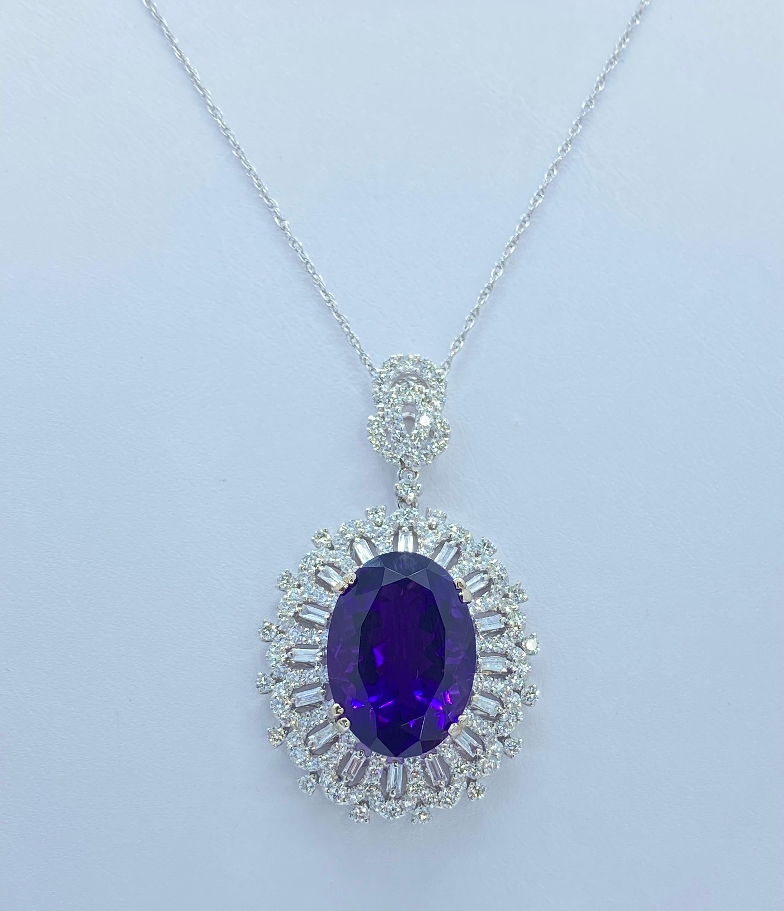 Very regal 18 karat white gold diamond and amethyst pendant has a combined approximate total weight of 17 carats. It is comprised of approximately 150 round brilliant cut and baguette shaped diamonds.  The oval shaped flower design features a