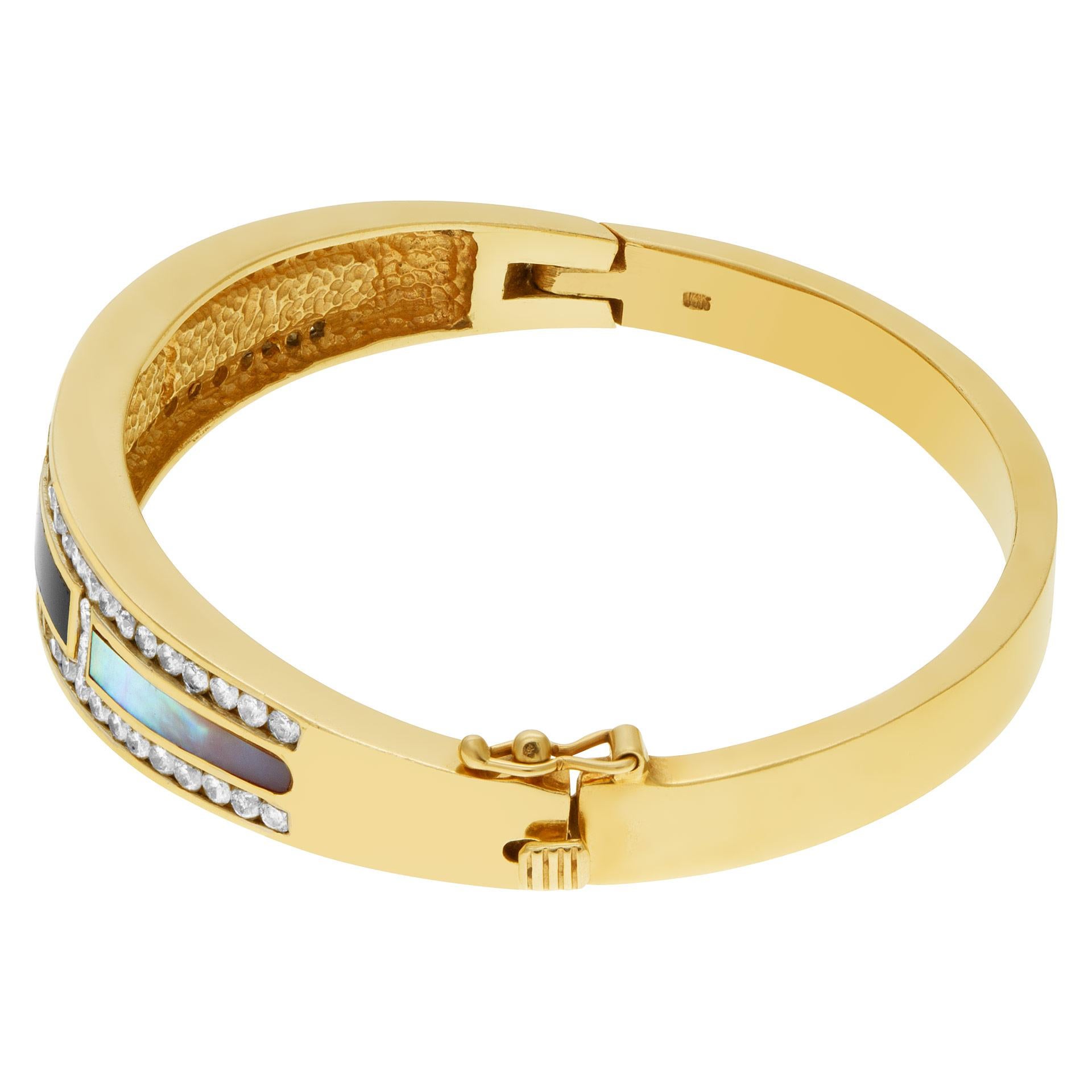 Regal diamond bangle in 14k yellow gold with mother of pearl, black onyx inlay and over 2 carats in diamonds. Bangle measures aproximately 11mm at the front.  Fits up to 7 inch wrist.

