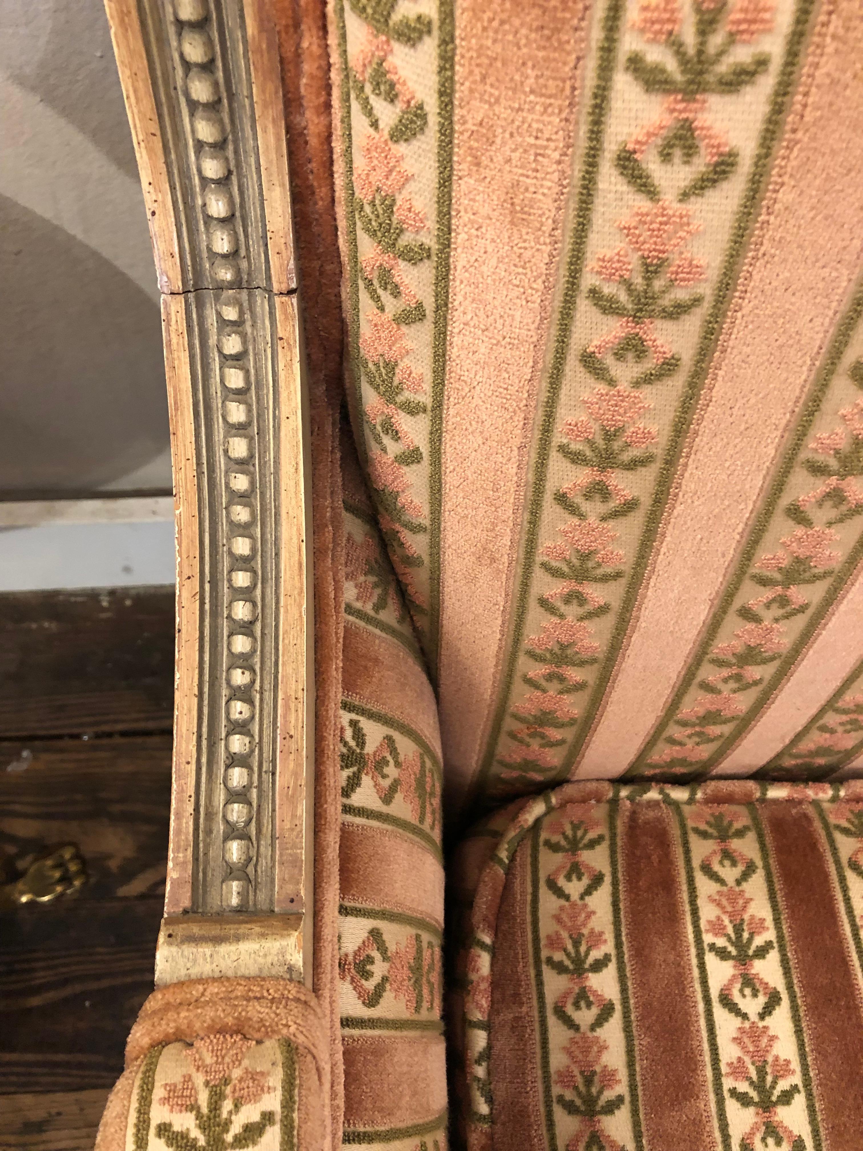 Classic French loveseat having painted carved frame and wonderful velvet upholstery with luxurious down filled seat cushion.  Finished front and back.