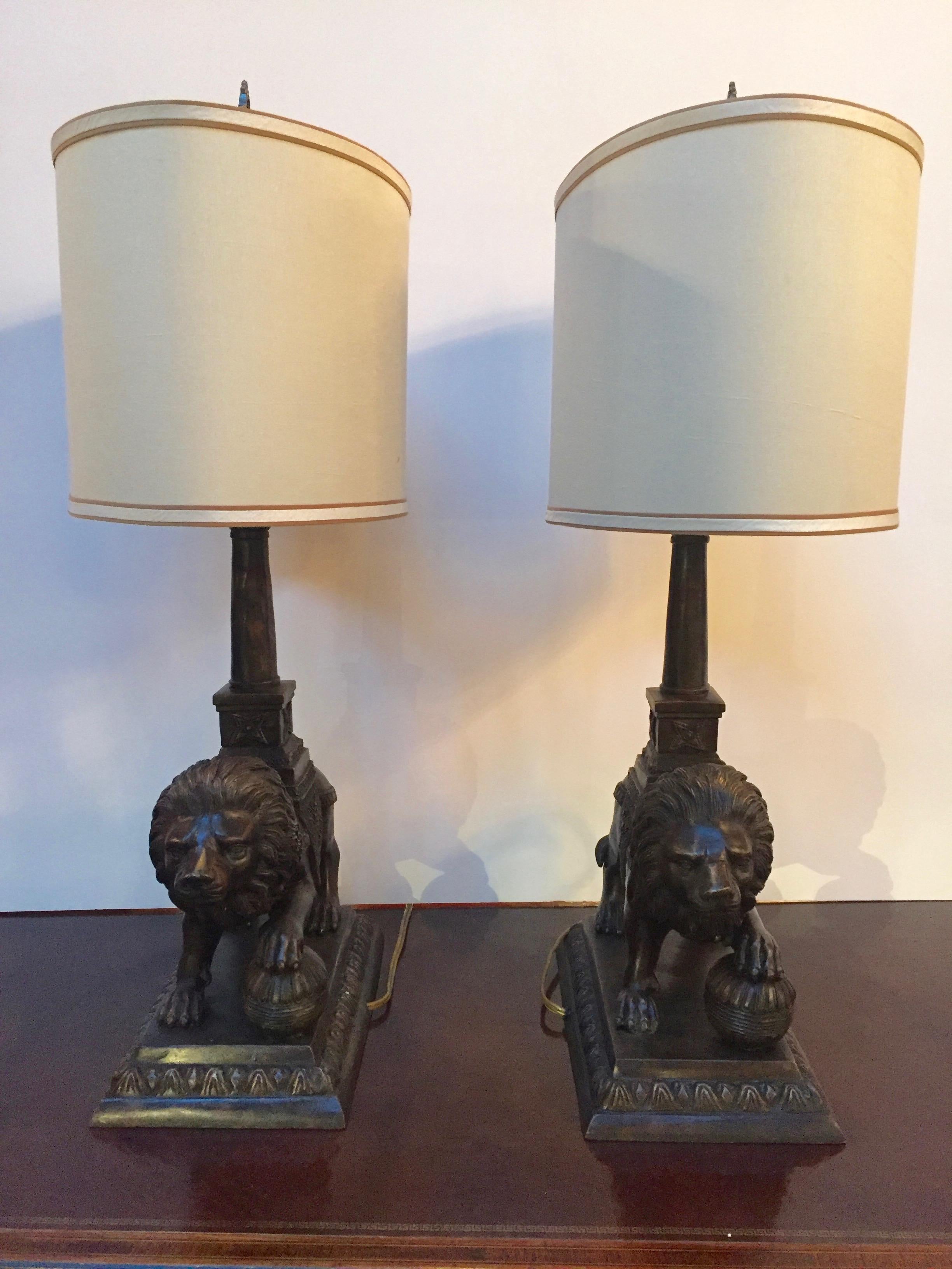 Impressive pair of lamps having bronze sculptures of lions on bronze bases.
Each lamp has one socket for 60 watt bulb.
16 x 10 shades.