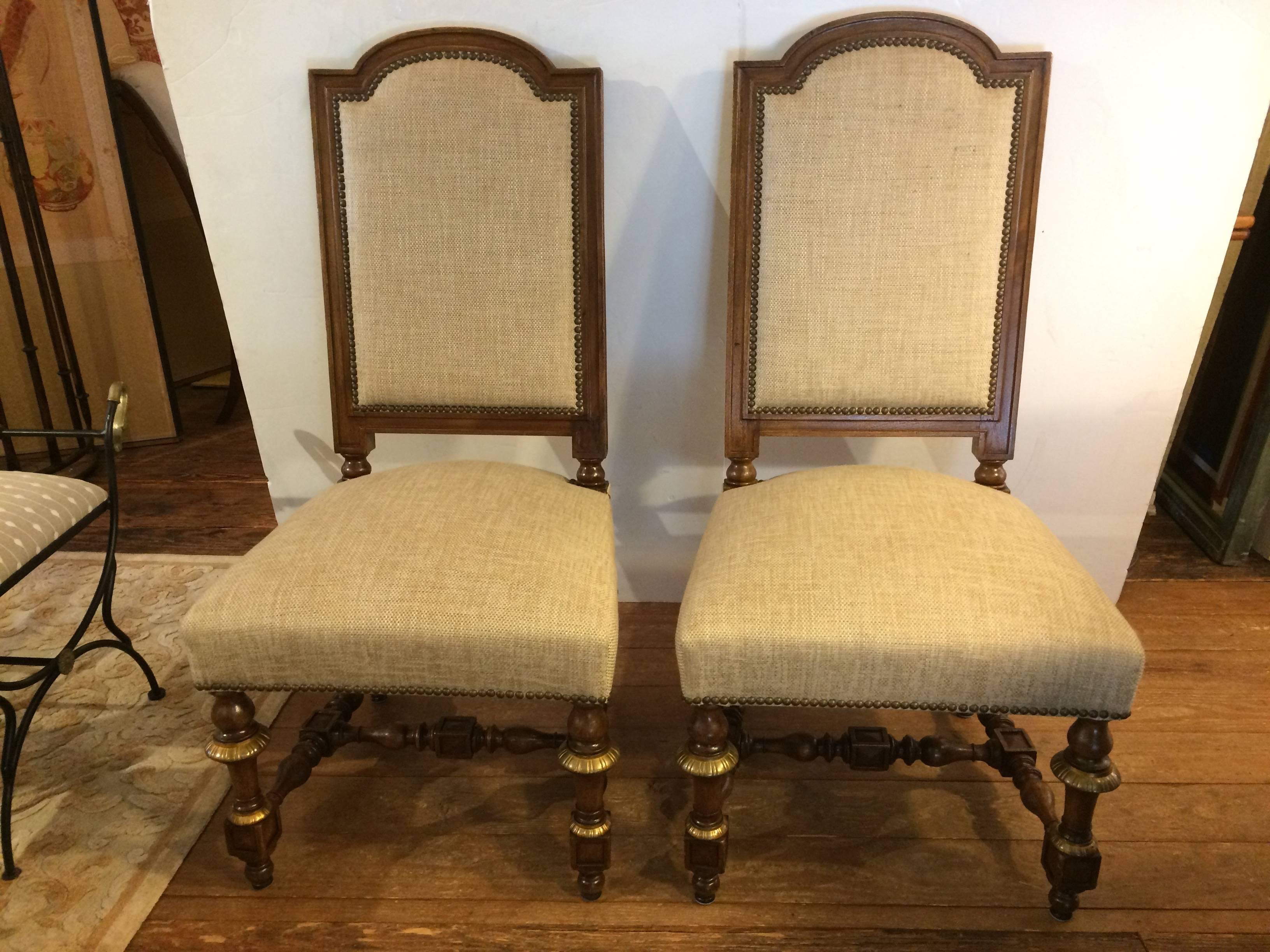 Set of 8 early French walnut/bronze ornamented chairs from St. Remy in Provence. Sturdy and comfortable with neutral Lee Jofa heavy linen fabric.  Very impressive in scale and were just tightened and waxed to bring to their full richness.

 seat