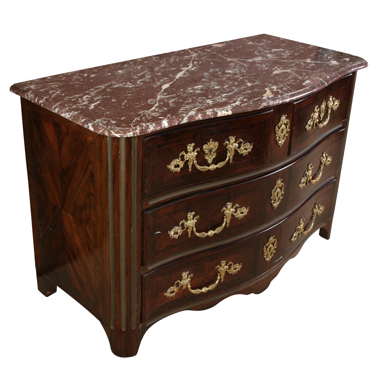 Regence style, brass and ormolu mount commode with serpentine shape front and Spanish rouge marble top. Drawers are fabric lined.