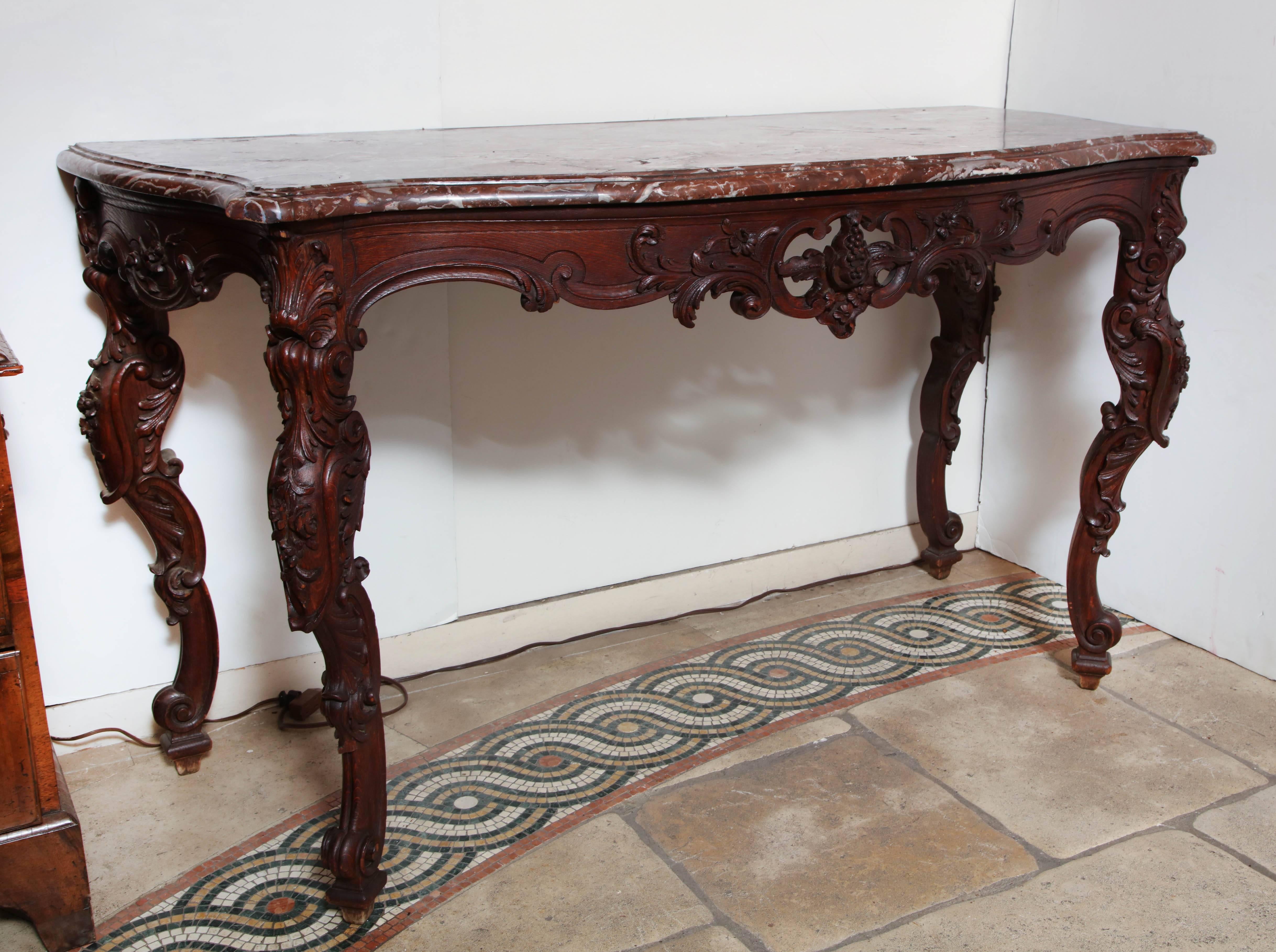French Regence carved walnut and Rouge marble-top console table with elaborately carved leaves and open on carved cabriole legs.