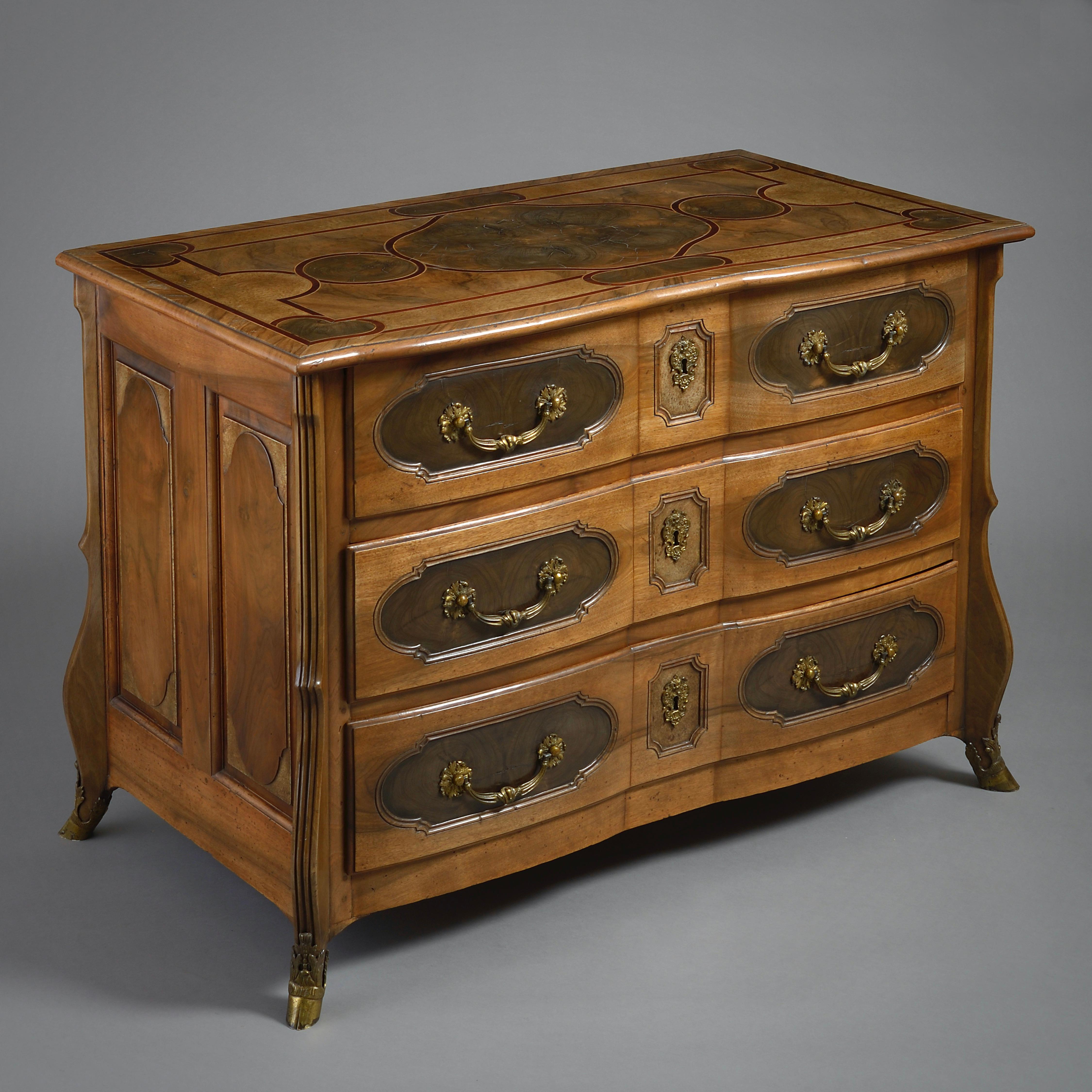 A Régence walnut, end-cut olive wood and burr-ash commode by Thomas Hache, Grenoble, circa 1730.
