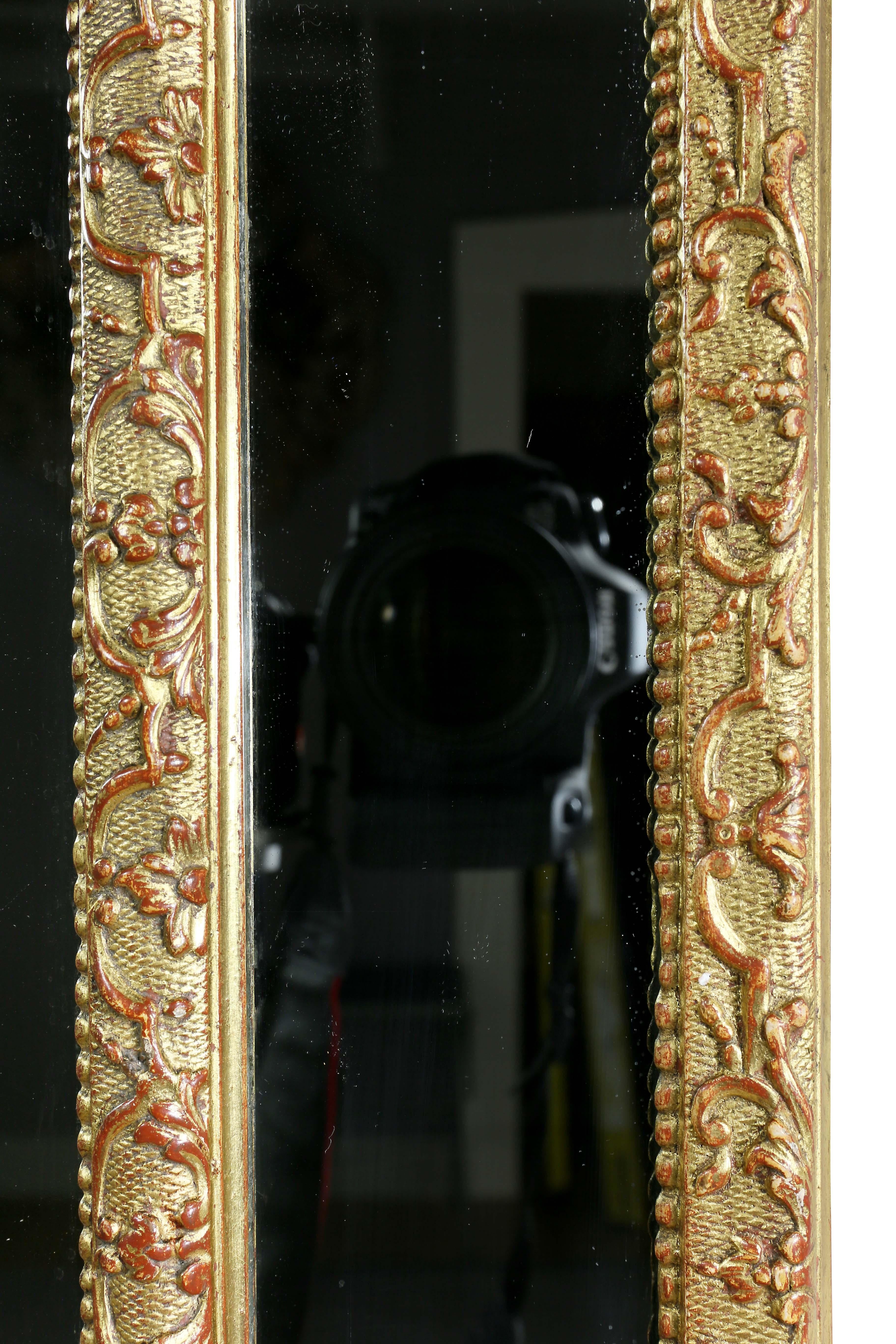 Mirror set within a mirrored border, giltwood inner and outer border.