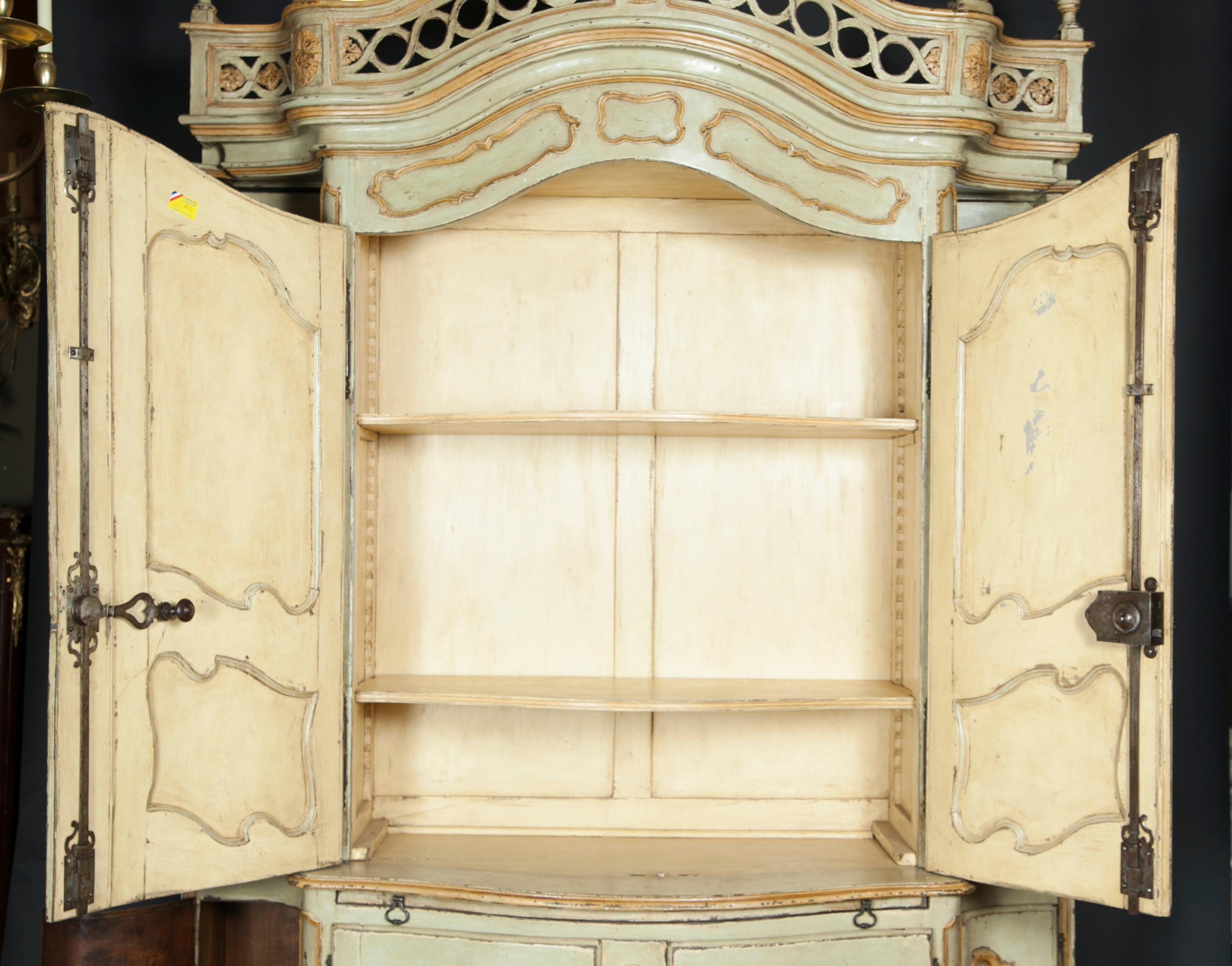 This early 18th century painted Buffet a Deux Corps is truly immaculate. The piece is a true period piece, made in the Regence era when Louis XV was too young of age to rule so the country was ruled temporarily by King Phillipe D’Orleans. The