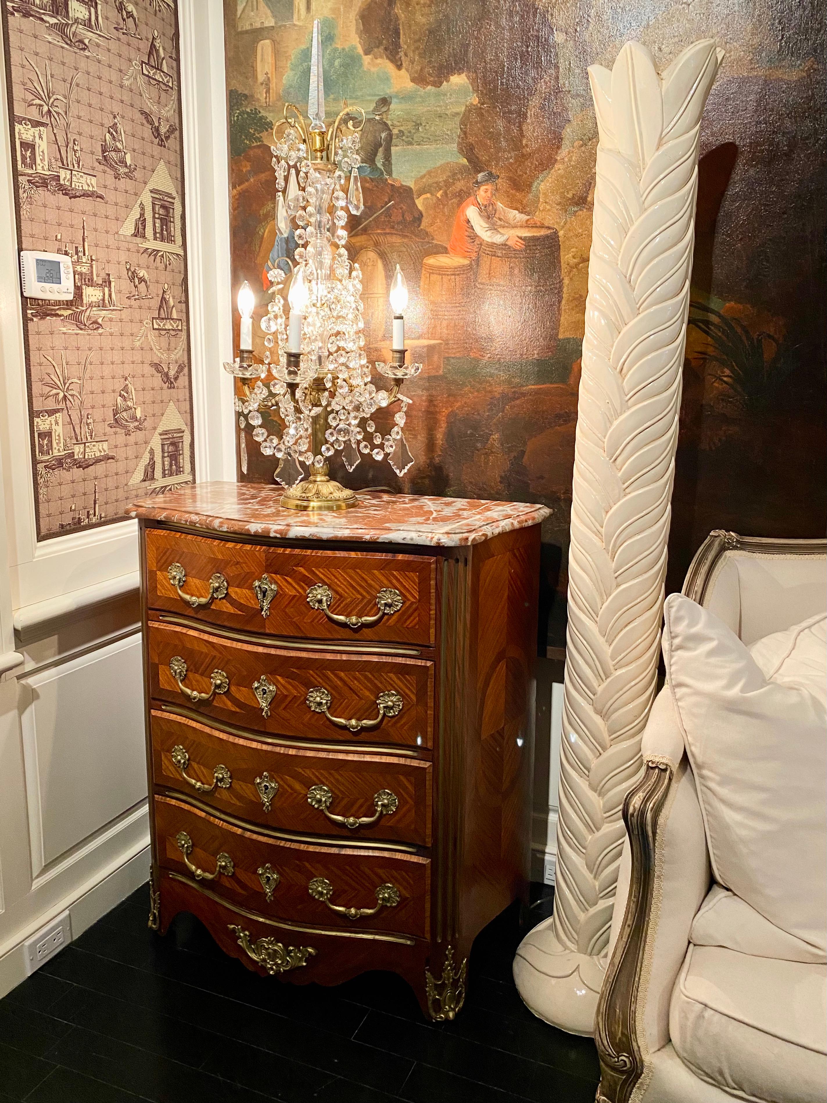French Regence style commode or chest of drawers, marble-top, 19th century. Diamond-shape parquetry veneer, four front drawers. Carved edges, red Languedoc marble top. Gilt bronze handles and details. Smaller size makes it a great, versatile