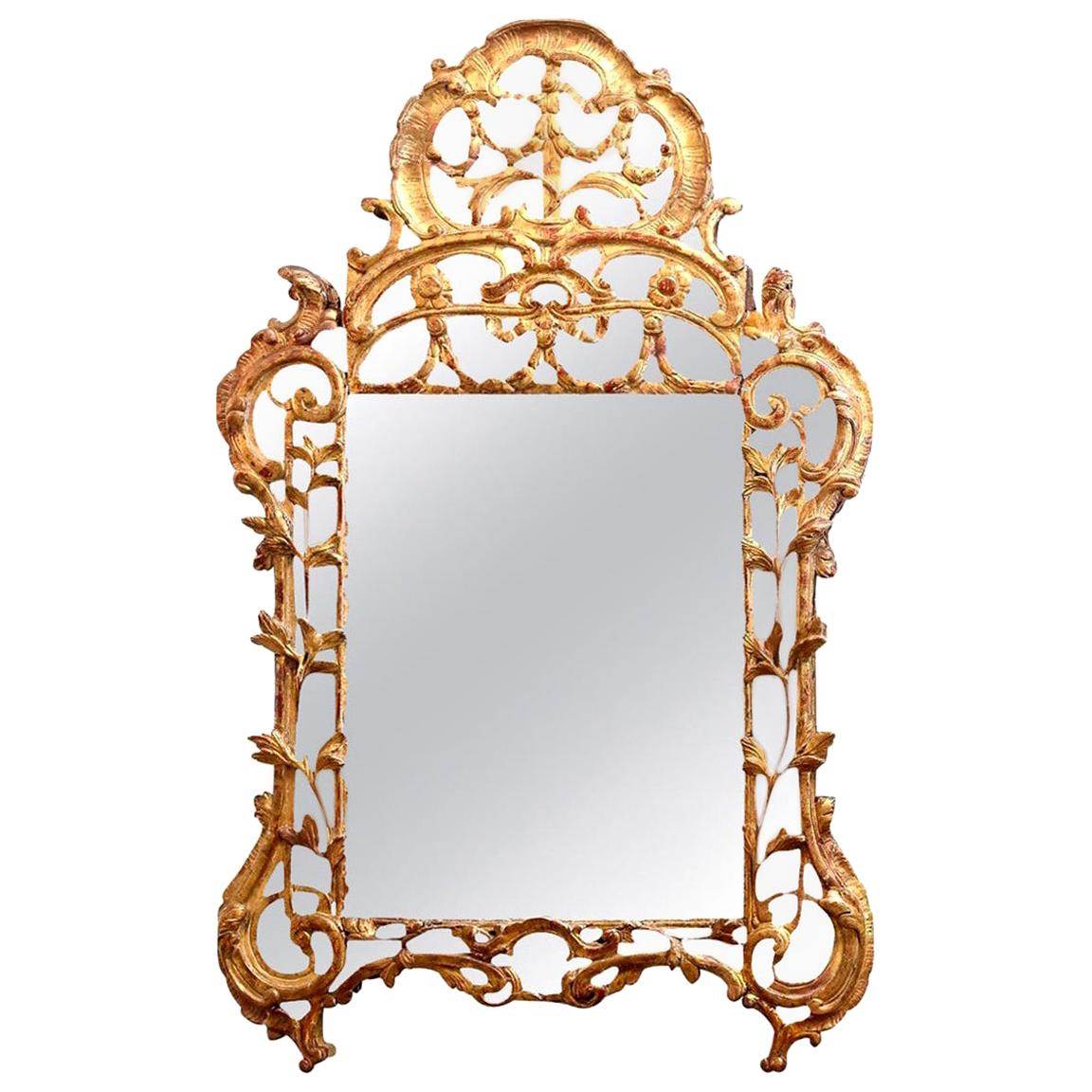 Regence period giltwood mirror, circa 1720-1730. This 18th century French mirror is finely carved with original (or very early) mirror glass. Mercury silvered mirror feature a sparkly, crystalline appearance behind its glass known as 