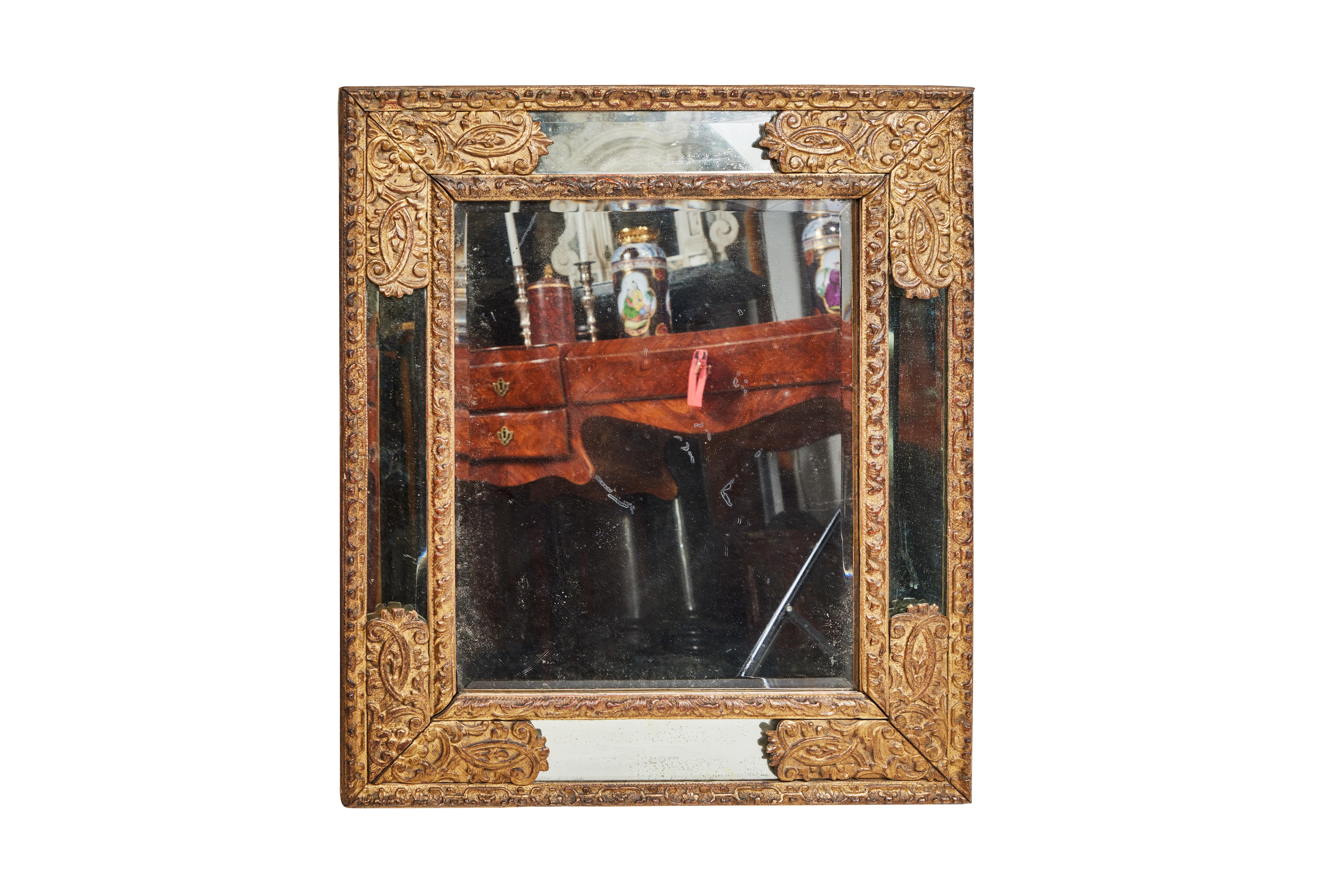 A completely original, turn-of-the-19th century mirror with hand-carved, gessoed and gold gilded foliate embellished over-frame. Private collection, Northern Italy.