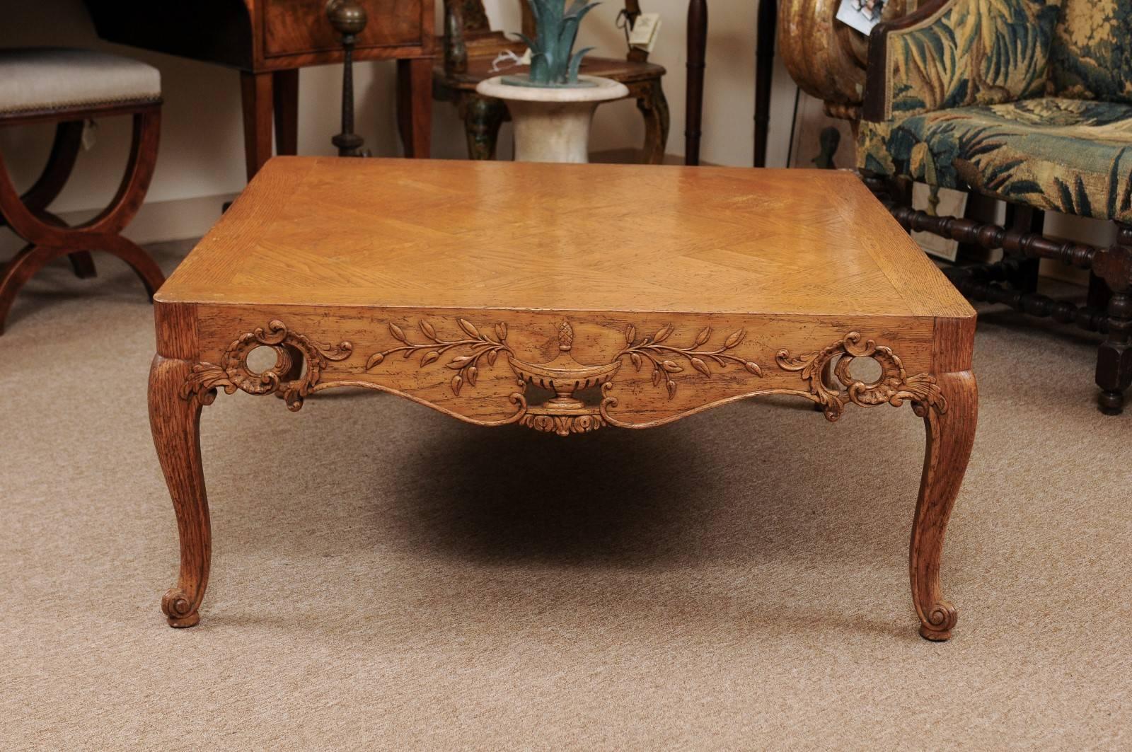 Large square French Regence style oak coffee table with parquet top and pierced carved apron.