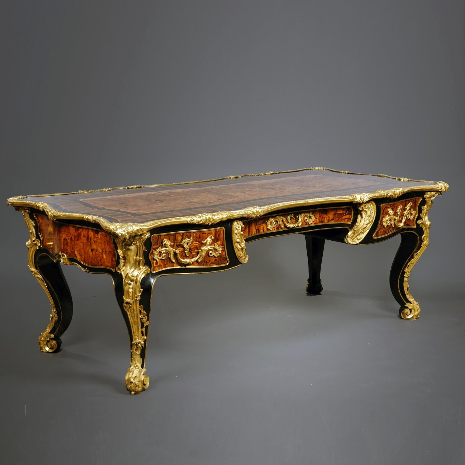 A magnificent and very rare Régence style marquetry inlaid grand bureau plat or writing desk.

Inscribed to the carcass 'Moreaux 72'.

Dating from the second half of the nineteenth century this magnificent and very rare bureau plat has finely