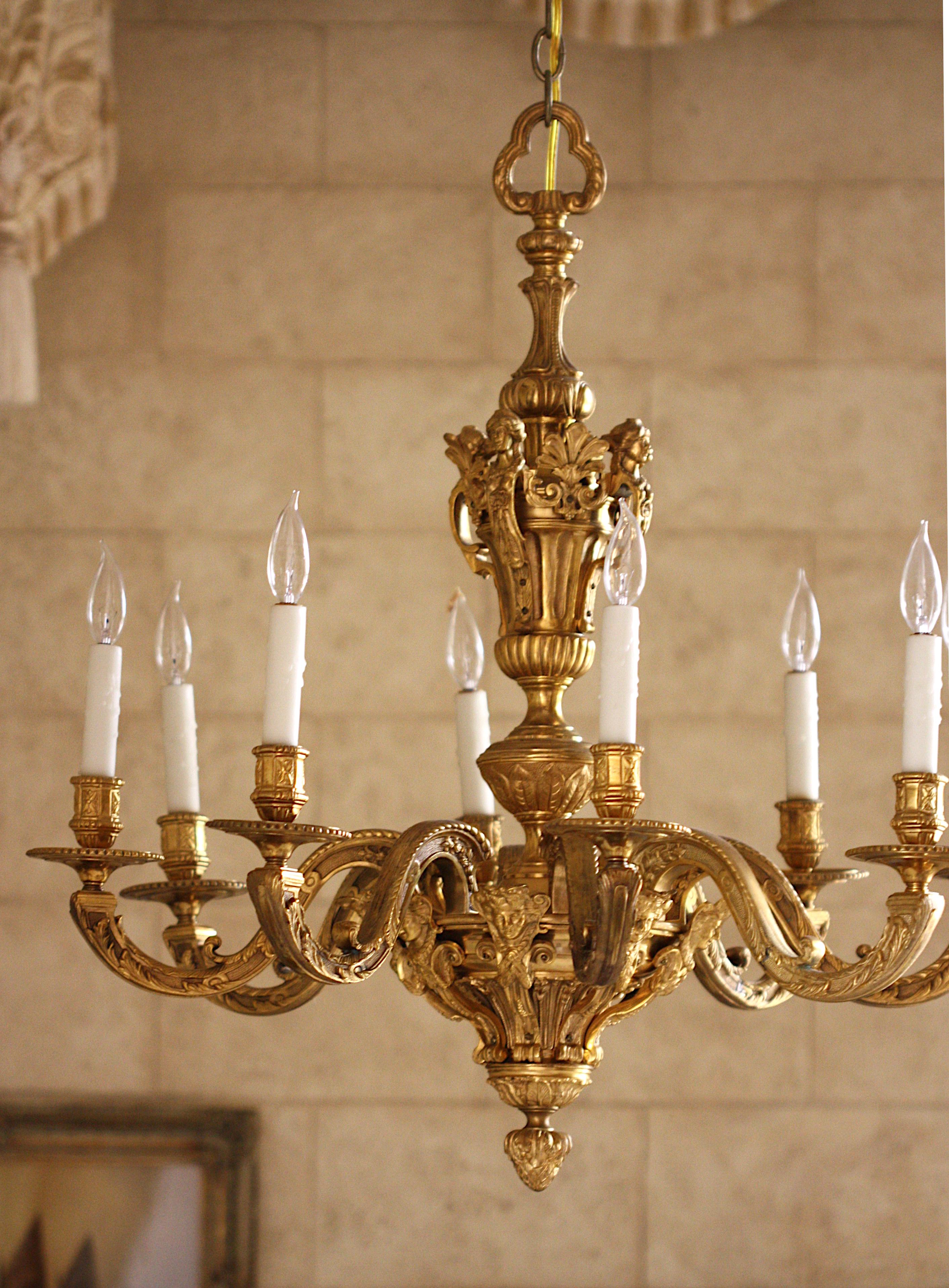 
Regence Style Ormolu Eight-Light Chandelier
19th Century. The urn and spherical cast standard headed by female masks and scrolls, scrolled arms with female masks, with scrolled arms cast with foliage and scrolls.
Height 34 in. (86.36 cm.)(approx.),