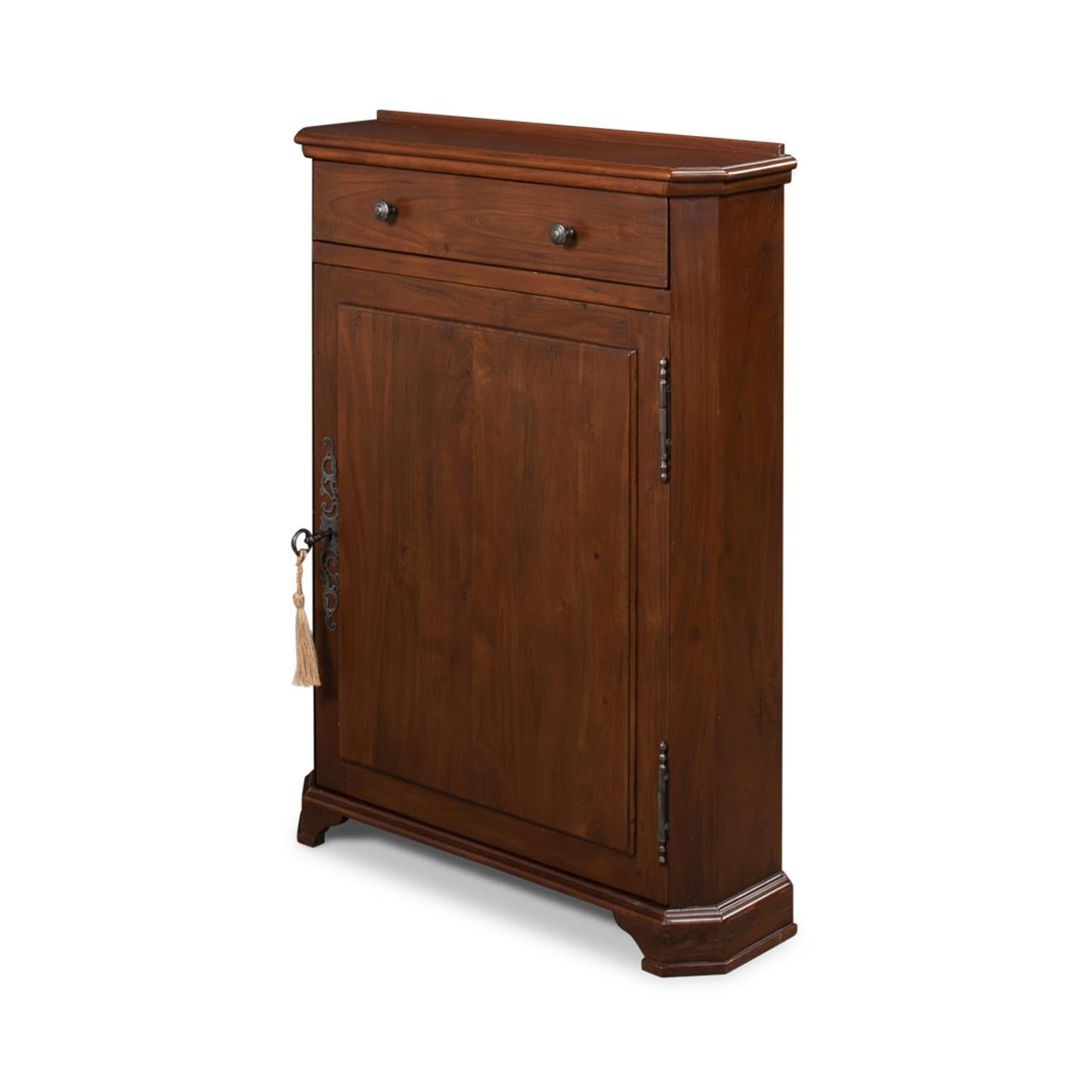French Regence style walnut side cabinet, this small versatile cabinet works well in almost any style of decor. With a wonderful warm walnut finish, the slim cabinet has a single drawer and cabinet door with a unique French escutcheon and key,