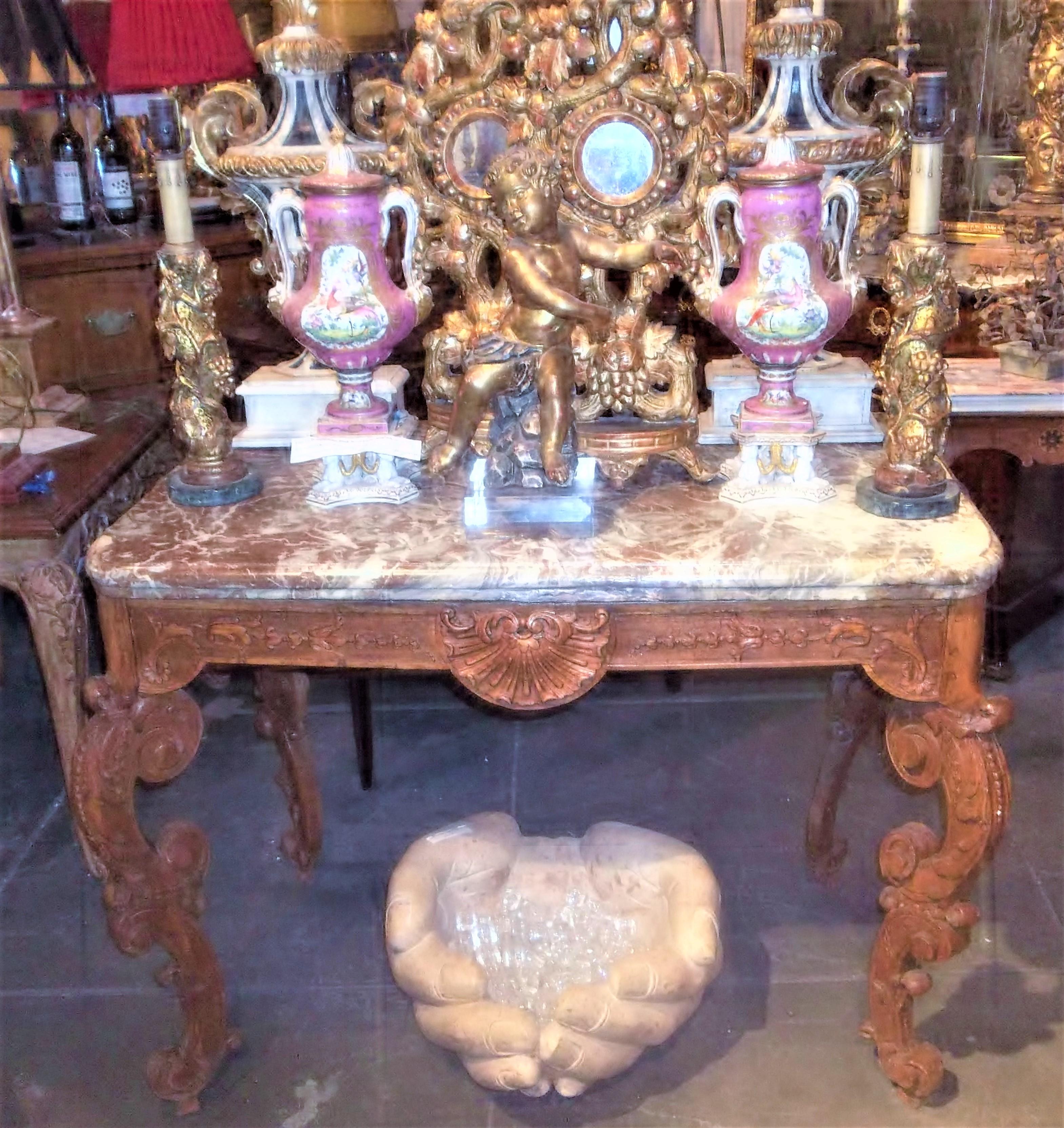 A profusely carved beechwood table in the transitional style of Regence to Rococo (Louis XV). Each leg comprised of two 