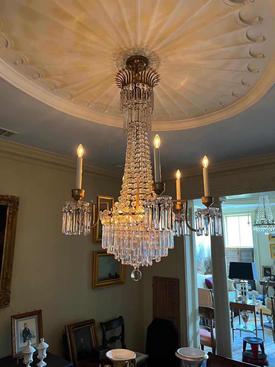 This outstanding fixture is the work of John Blades of Ludgate Hill, London. Blades was one of the premier chandelier makers in Regency England. A number of the chandeliers in Buckingham Palace were his work. The gilt bronze frame supports six arms