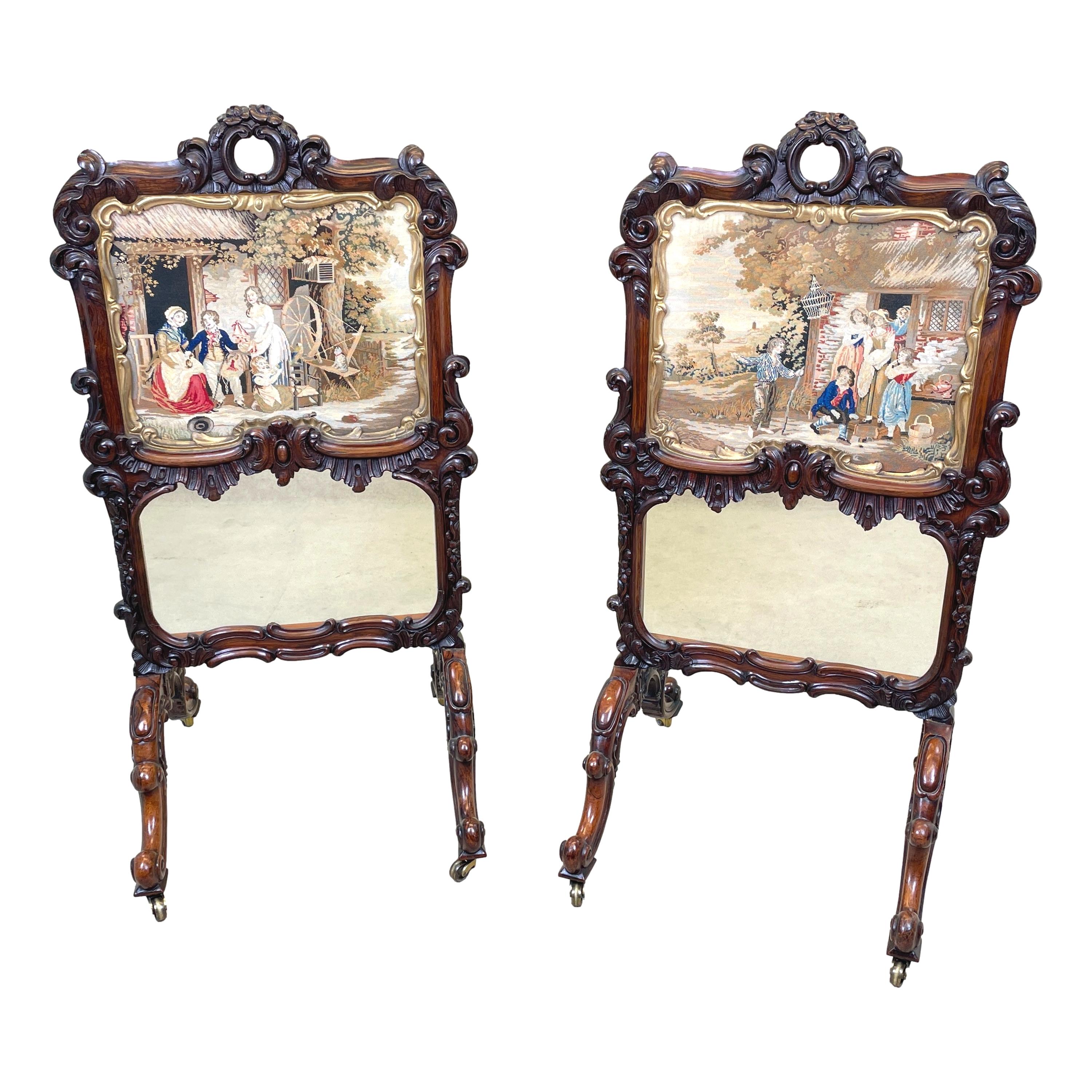 An exceptionally fine quality pair of regency rosewood fire screens, of very unusual design, having exceptional carved decoration to frames, enclosing original needlepoint tapestries above glazed panels, raised on cavred cabriole legs with original