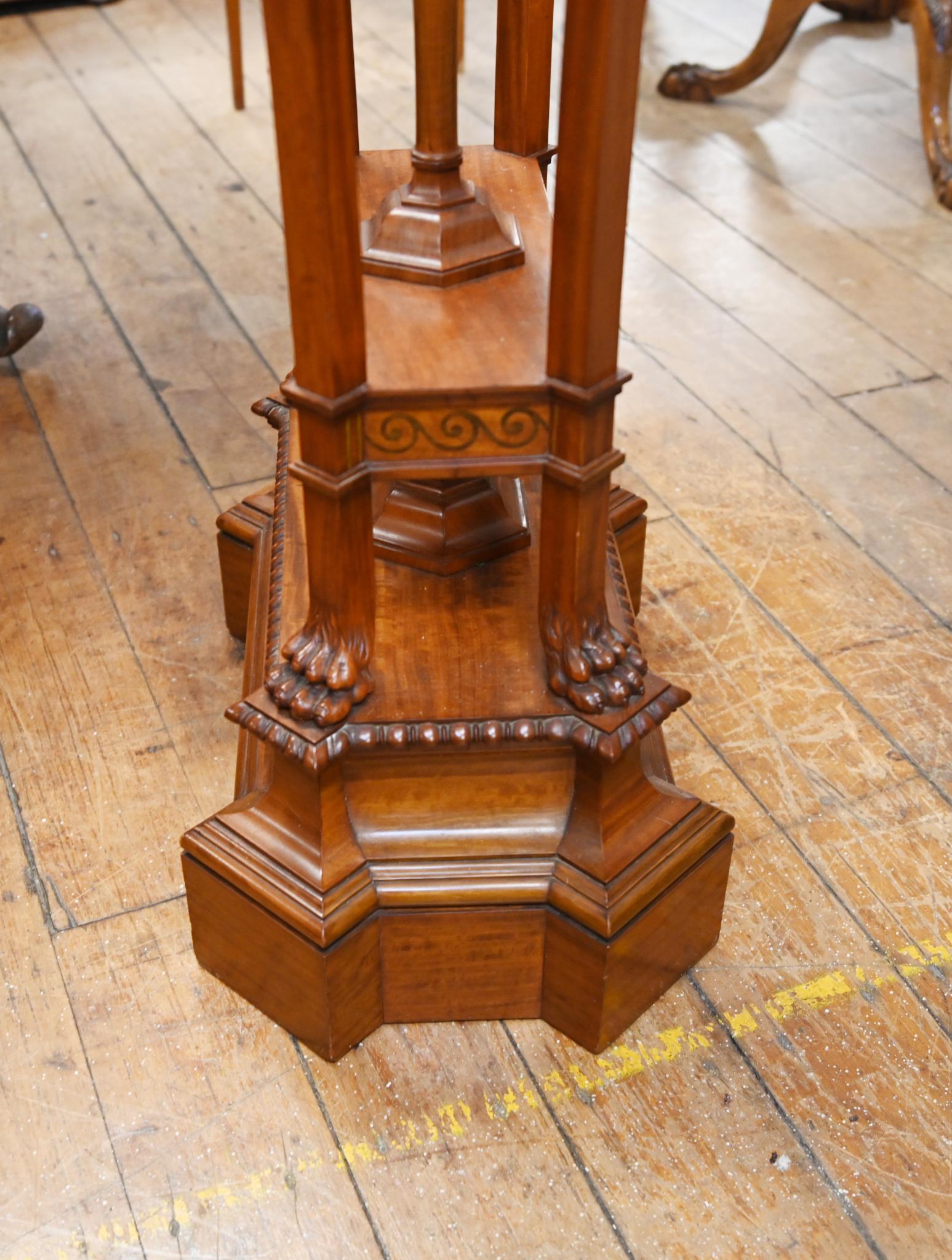 Fine quality and unusual late Regency pedestal stand in the Adams manner
Top features a Wedgewood porcelain plaque showing a procession of toga clad figurines
The whole aesthetic is one of classical refinement
Intricate carved rams head on each