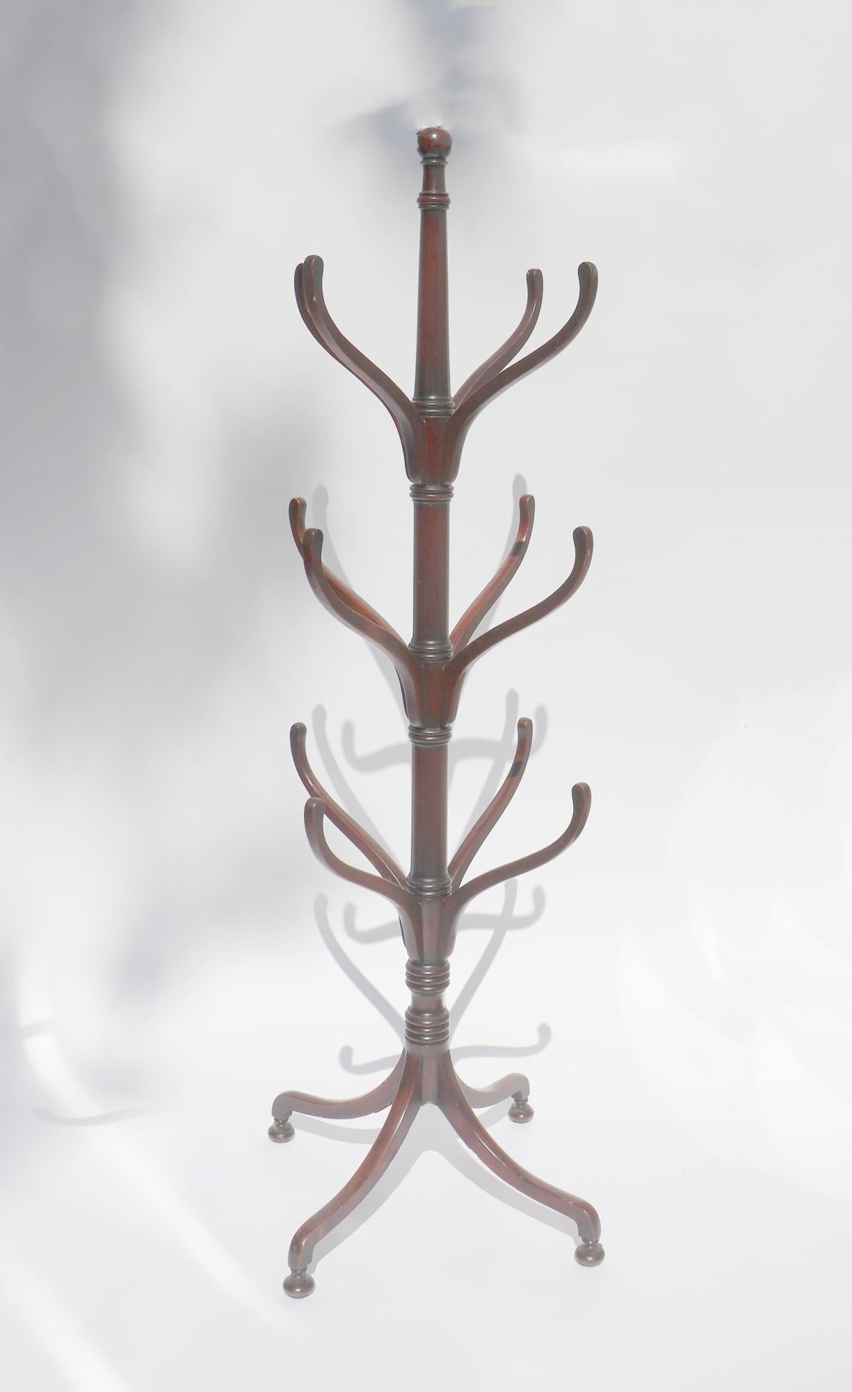 Late Regency Mahogany Hat or Coat Stand,
Circa 1840

The mahogany hat stand has three series of four hangers of reducing sizes.  The stand sits of four elegant splayed legs with small bun feet.

Dimensions:  70 3/4 inches high x 28 inches wide at